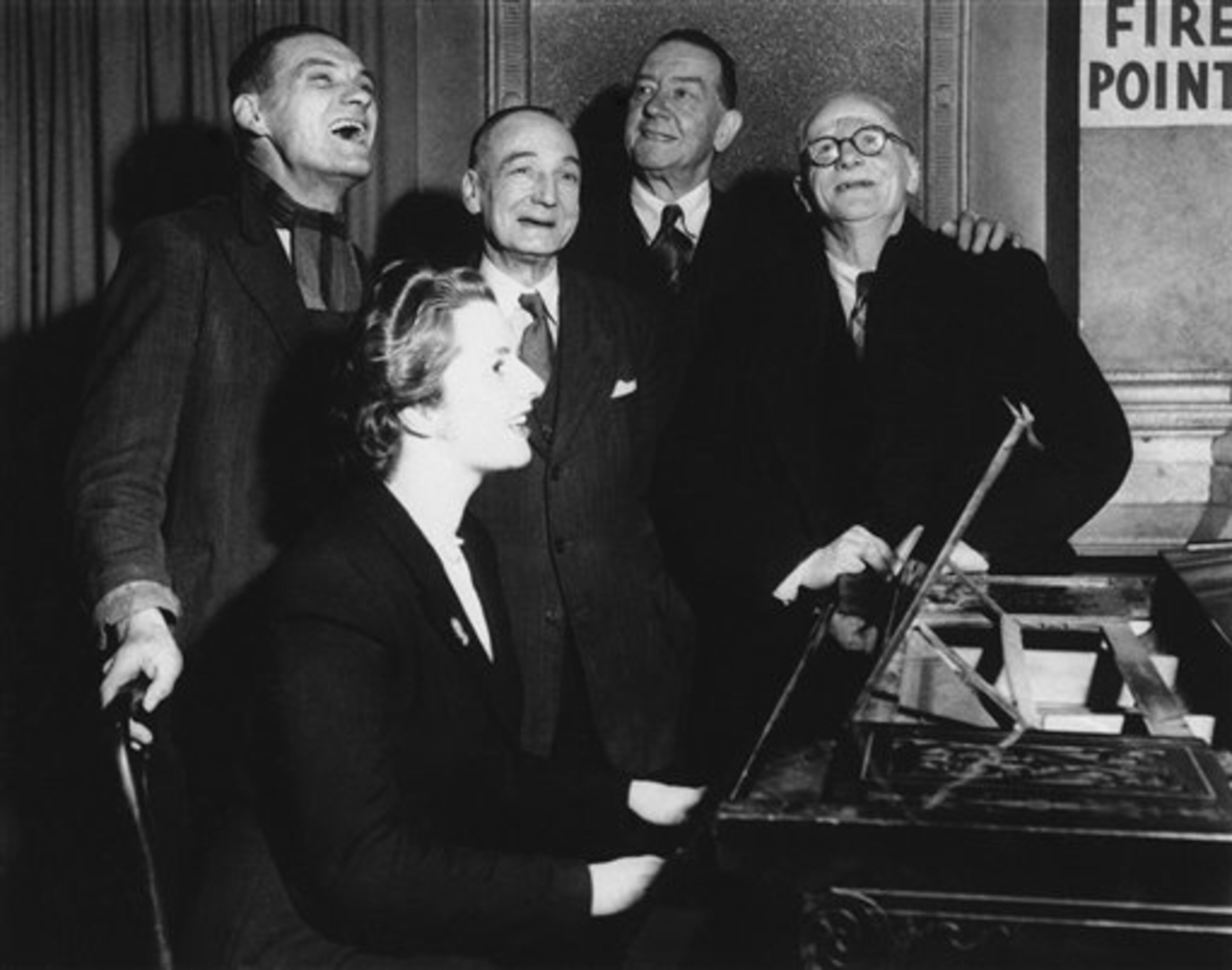 Conservative candidate at 23 years old and holder of an Oxford diploma, Margaret Roberts (later Thatcher) shows she is no ?blue stocking," 1950. After a brief political argument in the bar of the Bull Inn, Dartford, England in 1950, she accompanies four voters on the piano in a sing along. (AP Photo)