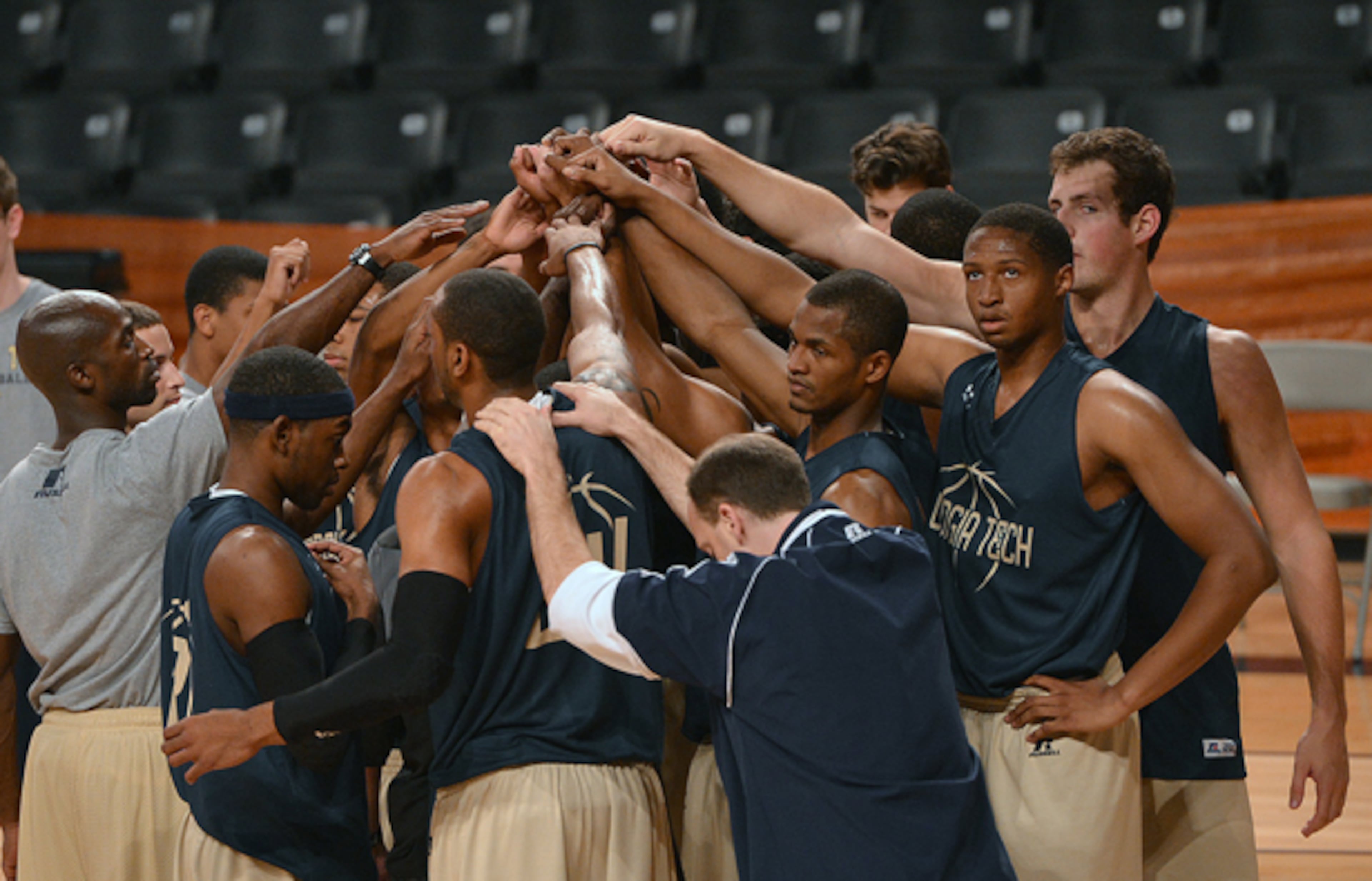 Members of the Georgia Tech's men basketball team put their hands together to close out practice.