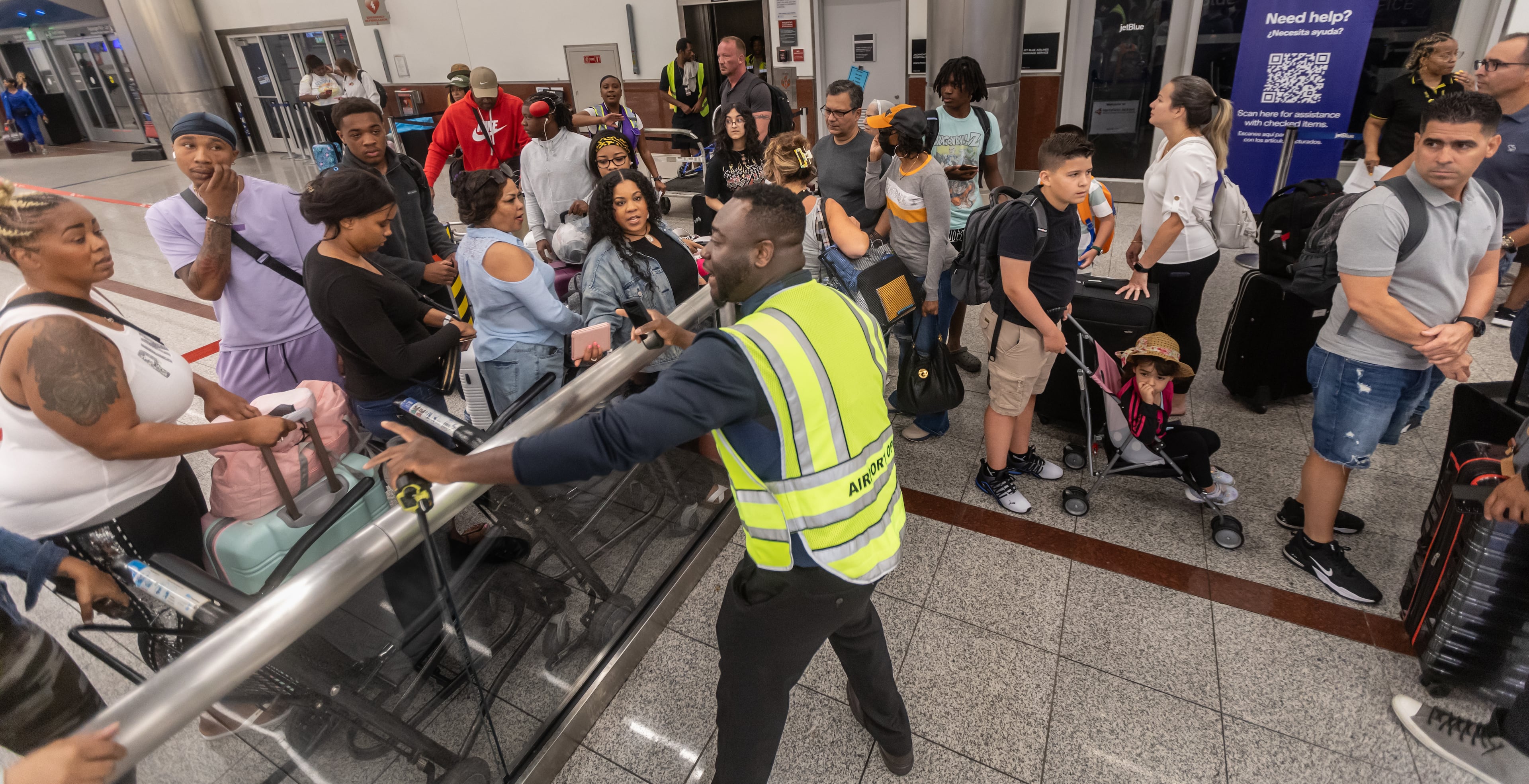 Crowd control at the North Terminal got testy early July 19, 2024, as a massive outage triggered by a faulty software update disrupted airlines, railways, banks, stock exchanges and other businesses. (John Spink/AJC 2024)