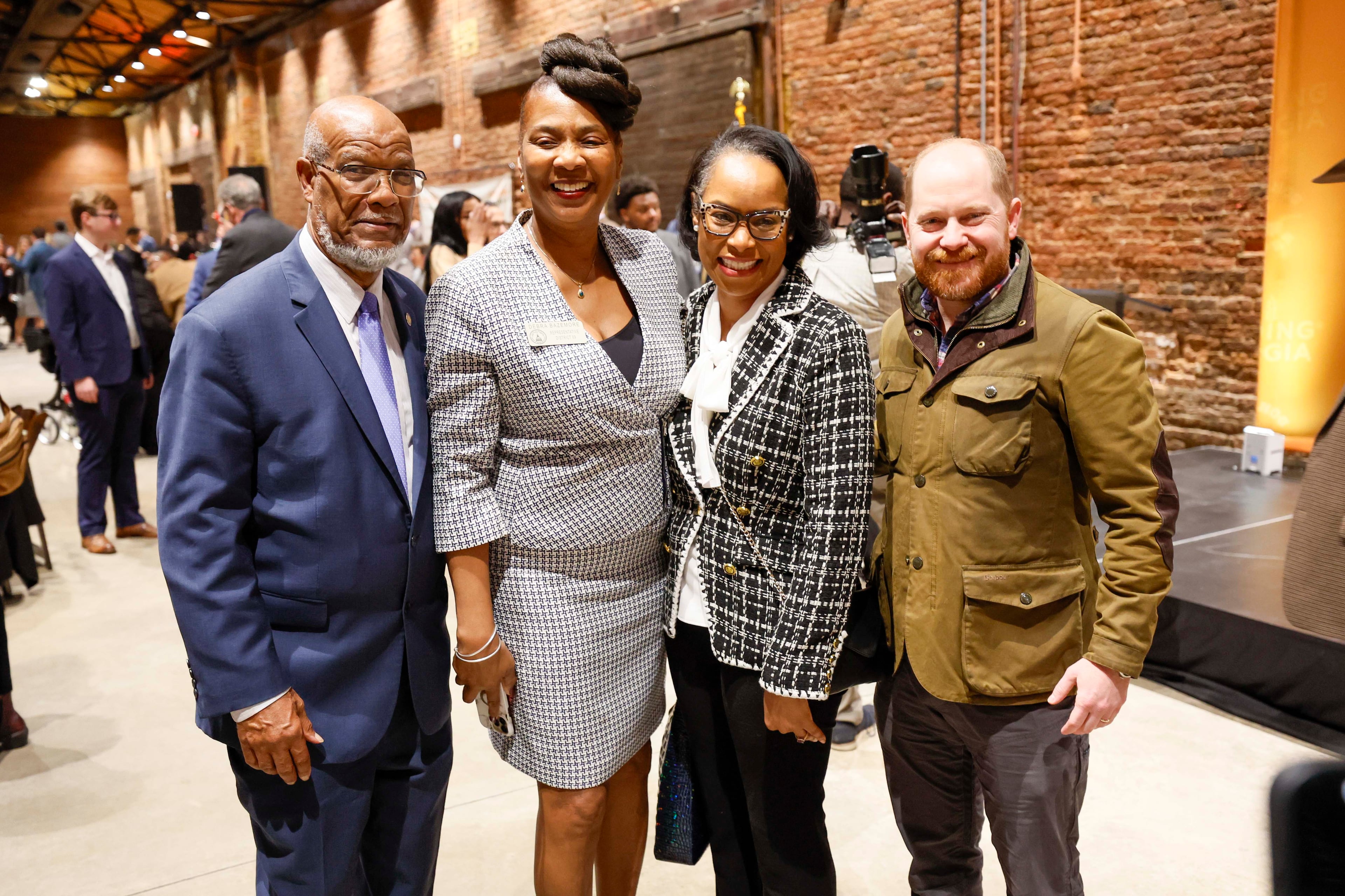 Former Democratic state Rep. Calvin Smyre (from left); state Rep. Debra Bazemore, D-South Fulton; Dr. LaShannon Spencer; and Georgia Democratic Party Chairman Charlie Bailey take time from mingling to have a photo taken. (Miguel Martinez/AJC)