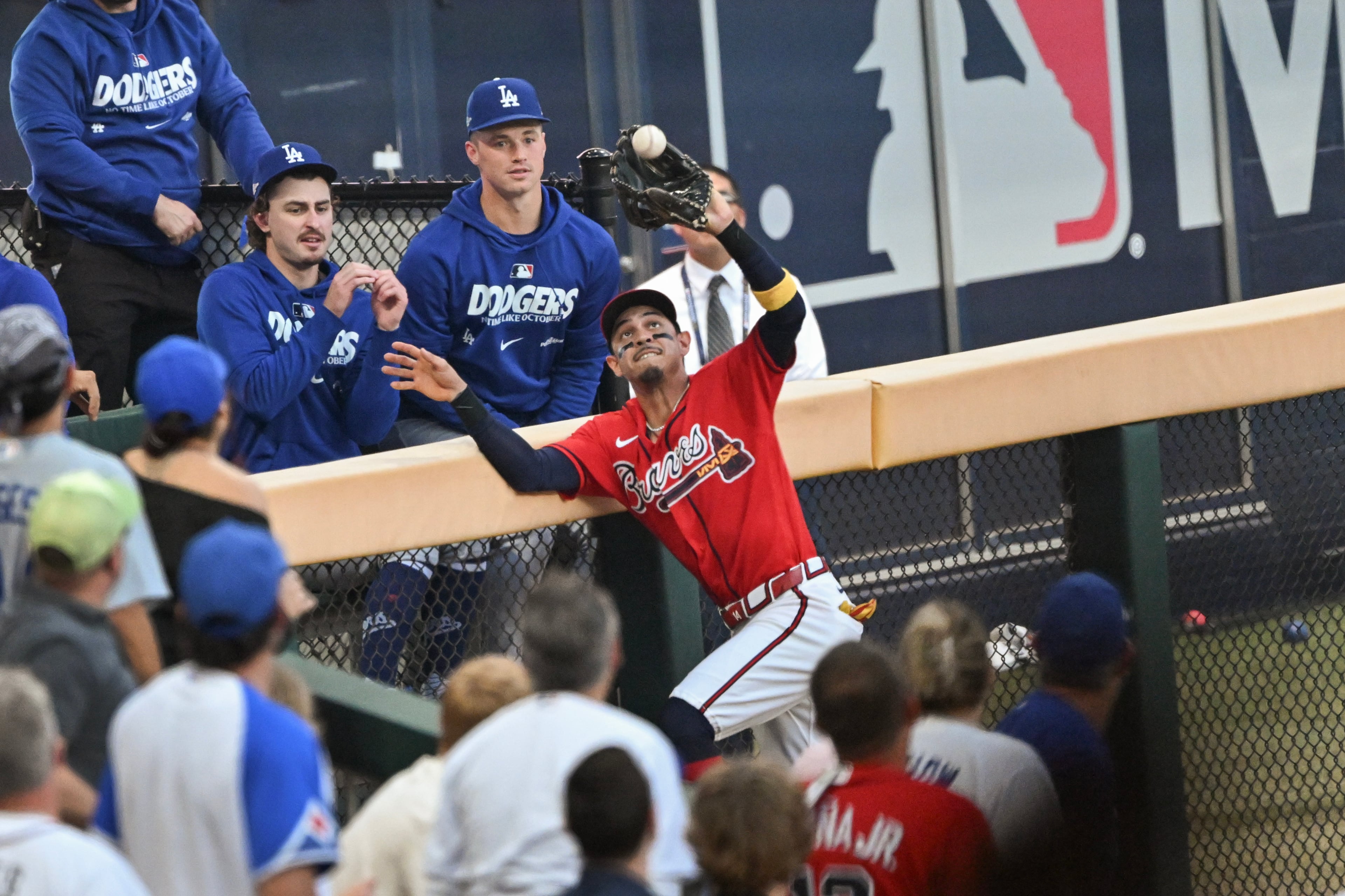 Atlanta Braves left fielder Mauricio Dubón (14) catches a deep fly ball hit by Los Angeles Dodgers first baseman Freddie Freeman during the third inning of Game 3 of the MLB National League Division Series between the Atlanta Braves and the Los Angeles Dodgers, Tuesday, Oct. 6, 2026, in Atlanta. (Hyosub Shin/AJC)