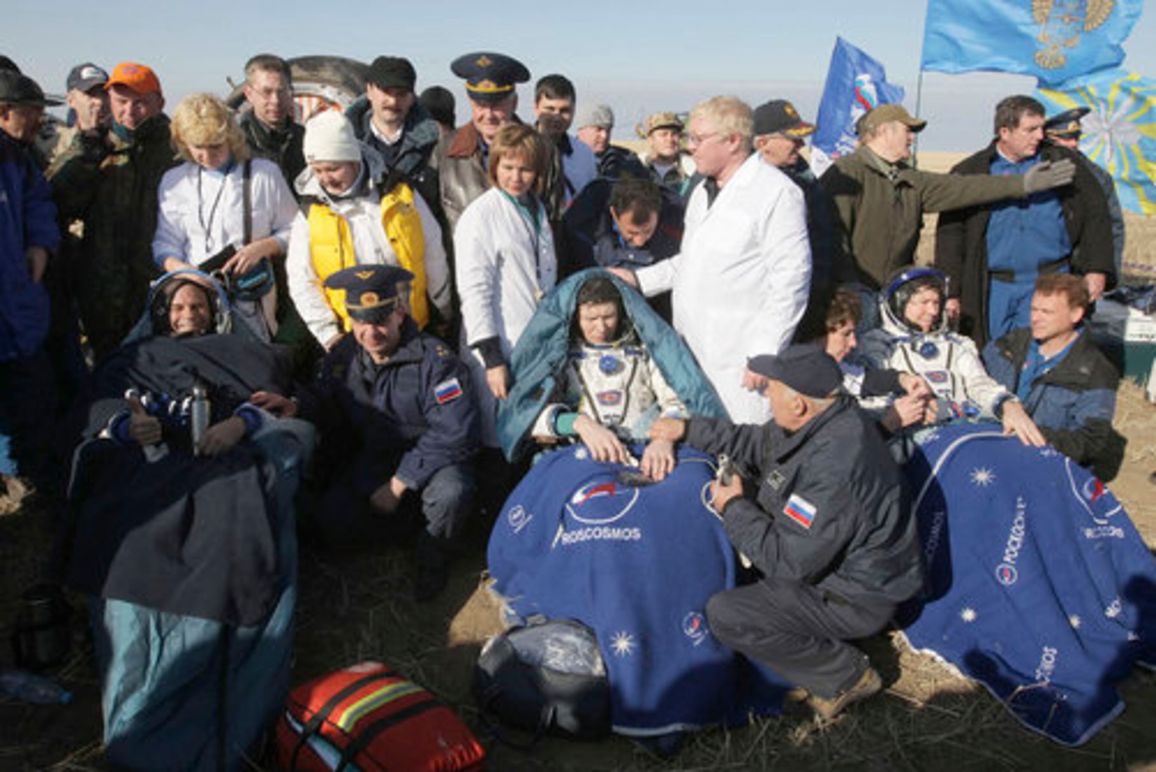 Russian search and rescue service specialists assist Laliberte, front left, and the members of the 20th main mission to the International space station Russian cosmonaut Gennady Padalka, front center in white, and NASA astronaut Michael Barratt, front second right in white.