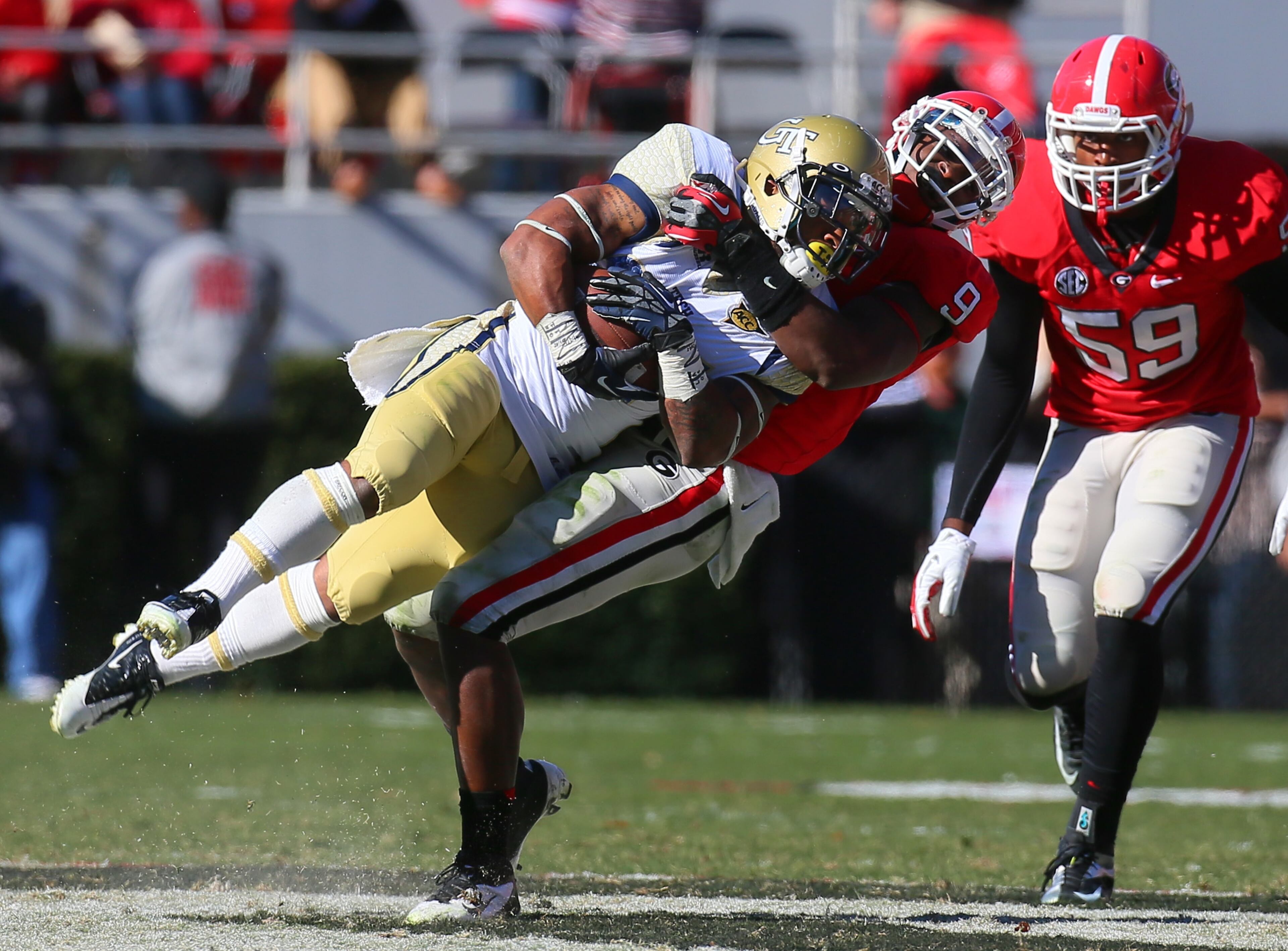 Georgia's Alec Ogletree (9) tackles Georgia Tech's Robert Godhigh (25) in the first half.