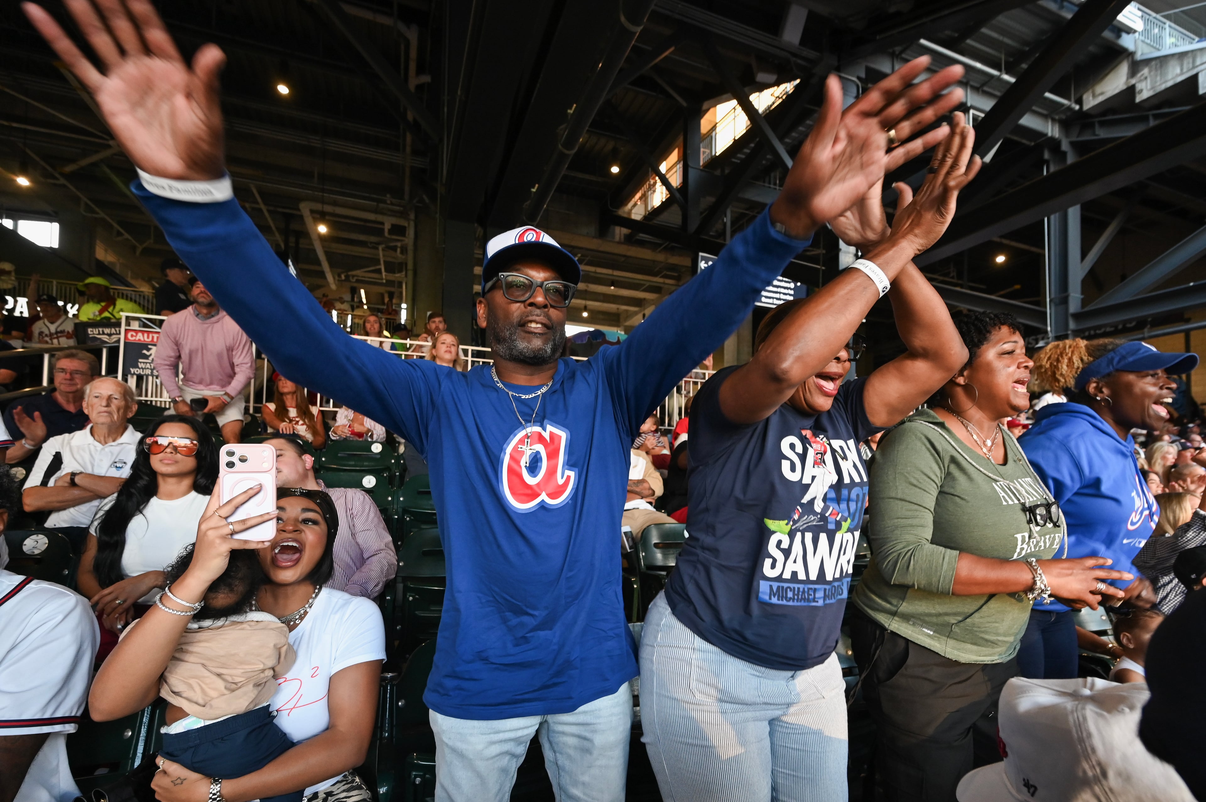 Michael and LaTaucha Harris watch their son Atlanta Braves center fielder Michael Harris II single on a bunt during the second inning of Game 3 of the MLB National League Division Series between the Atlanta Braves and the Los Angeles Dodgers, Tuesday, Oct. 6, 2026, in Atlanta. (Hyosub Shin/AJC)