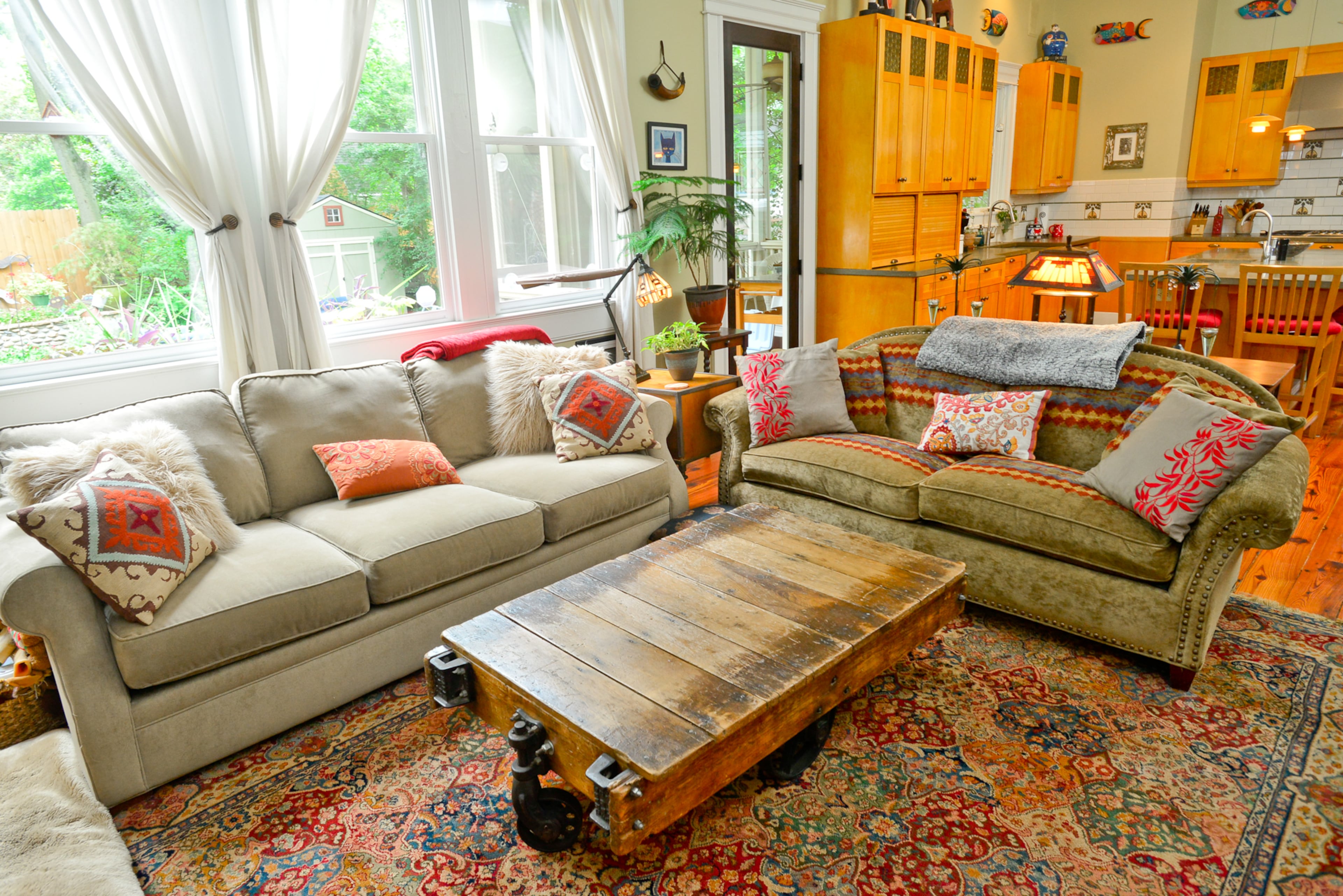 Morgan Shallcross and Judi Jacobs combined furniture from their individual homes when they moved into the Inman Park house in 2010. The coffee table is an antique warehouse cart they purchased at Scott Antique Markets and refinished.