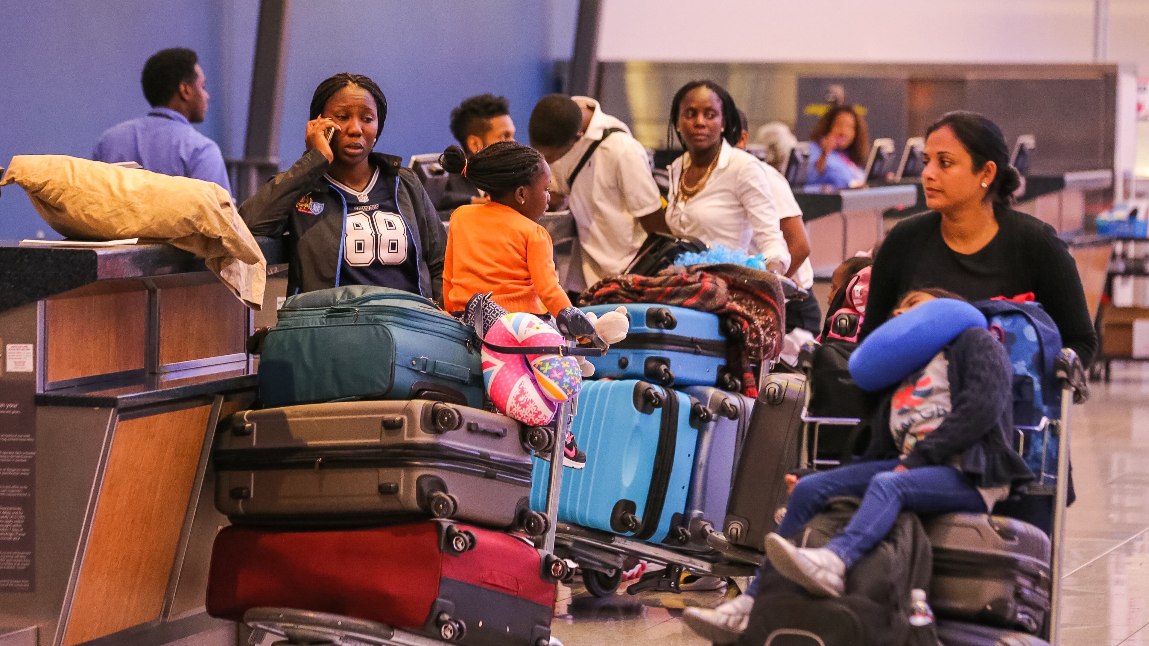 After sitting on a plane for four hours, Mercilina Oladejo and daughter Charis, 3, learned they would be put up in an Atlanta hotel. Charis is supposed to start school in the United Kingdom this week. JOHN SPINK / JSPINK@AJC.COM