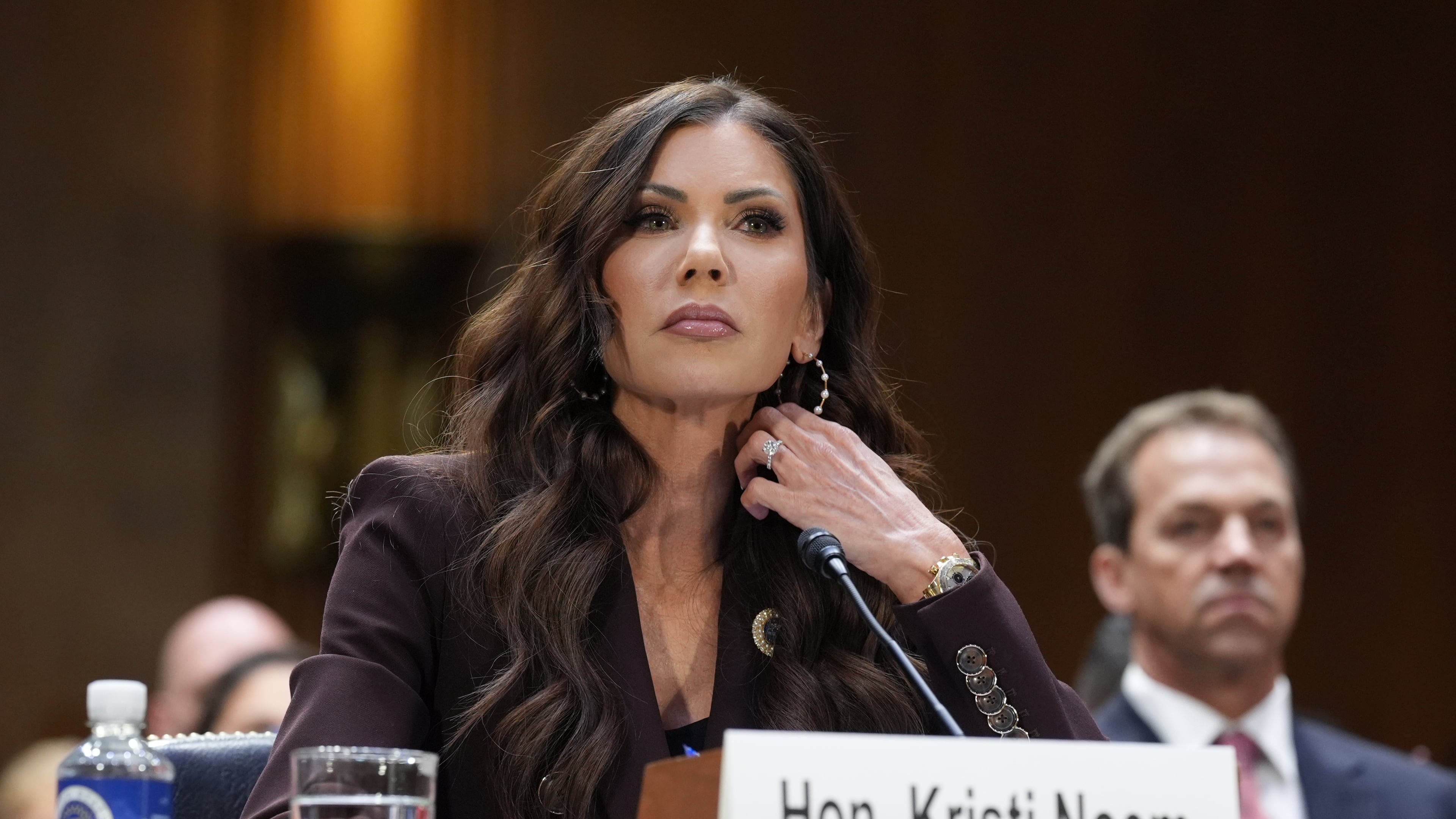 FILE - Homeland Security Secretary Kristi Noem, center, with her husband Bryon Noem, right, seated behind her, appears for an oversight hearing before the Senate Judiciary Committee, at the Capitol in Washington, March 3, 2026. (AP Photo/J. Scott Applewhite, File)