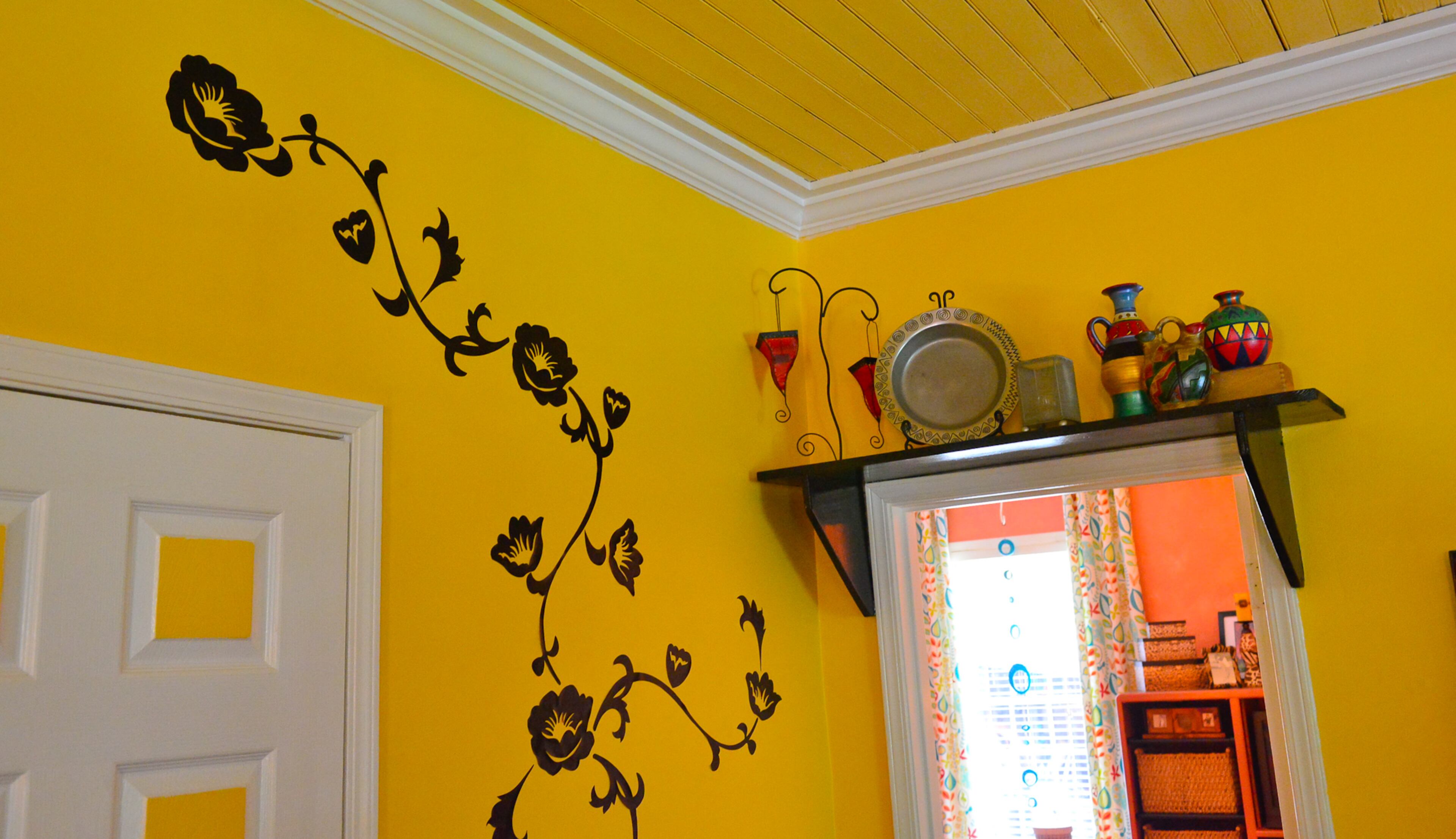 The wood ceilings in the dining room are believed to be original to the home. The high ceilings - another favorite feature of the homeowners - also make room for treasures to be displayed above door frames and molding.