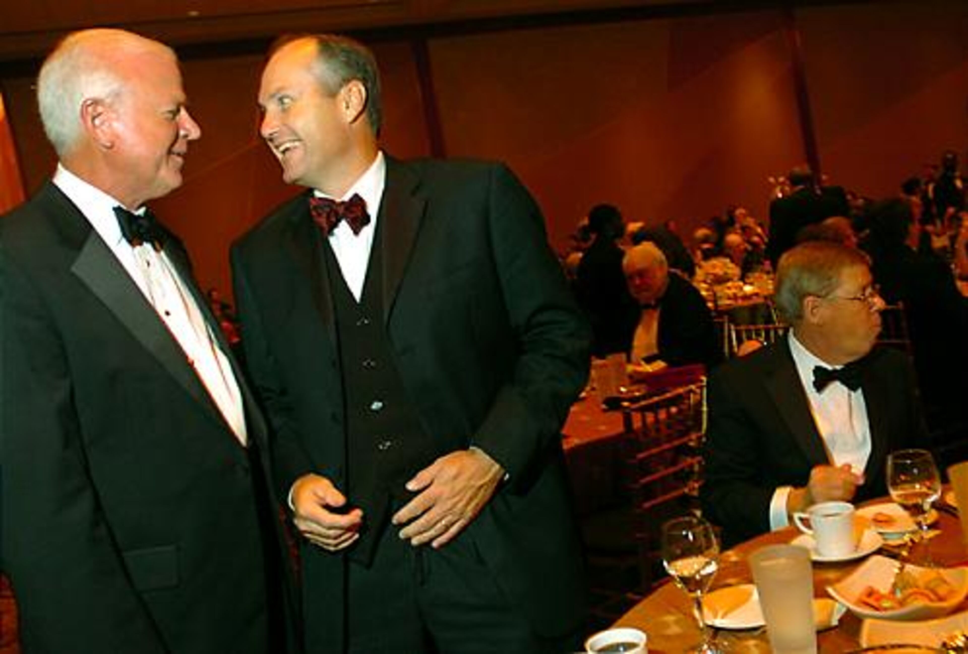 United States Senator Saxby Chambliss (from left) and Georgia Lieutenant Governor Casey Cagle engage in a conversation as Senator Johnny Isakson dines on his meal.