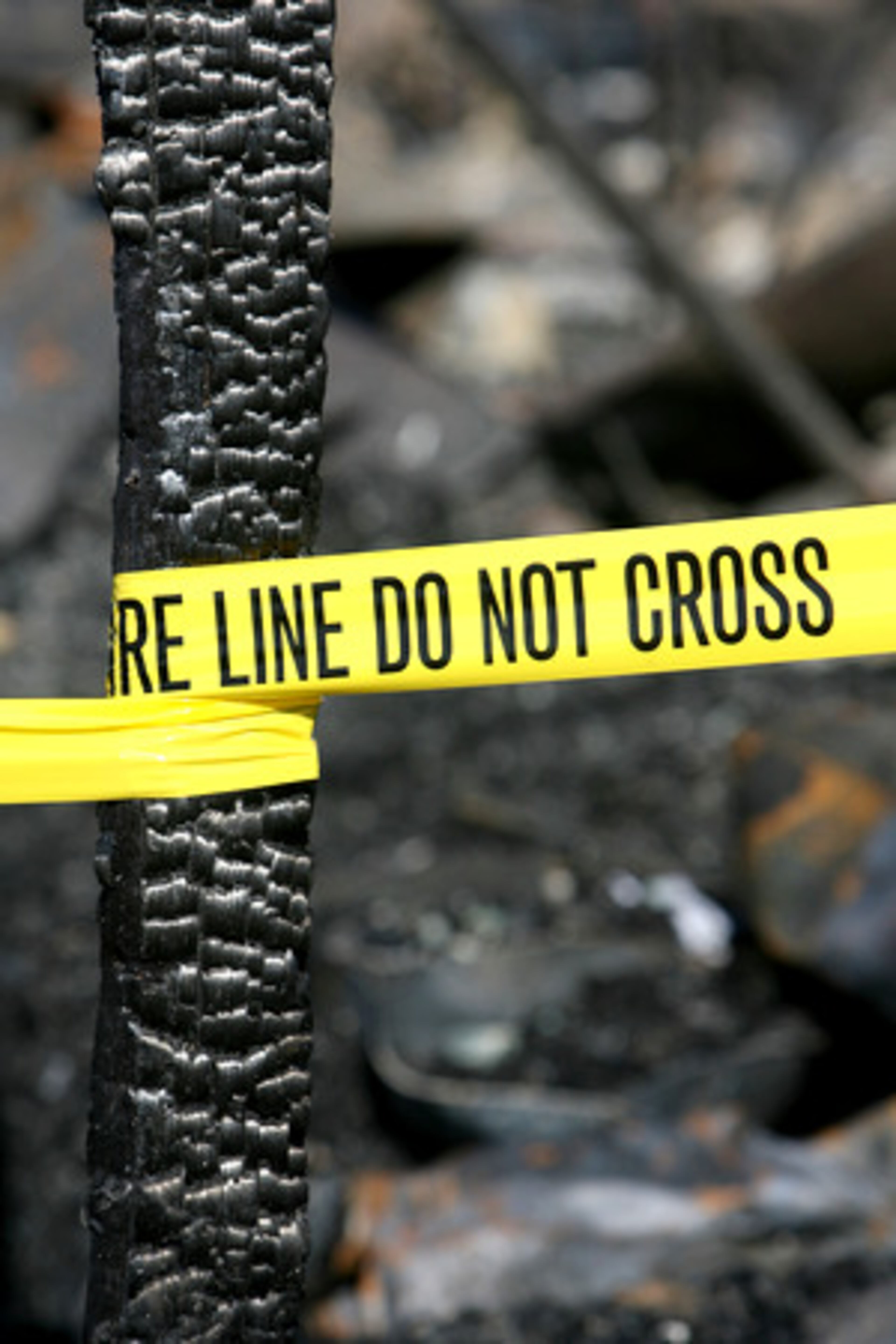 Yellow tape wrapped around one of the building's remaining structures.