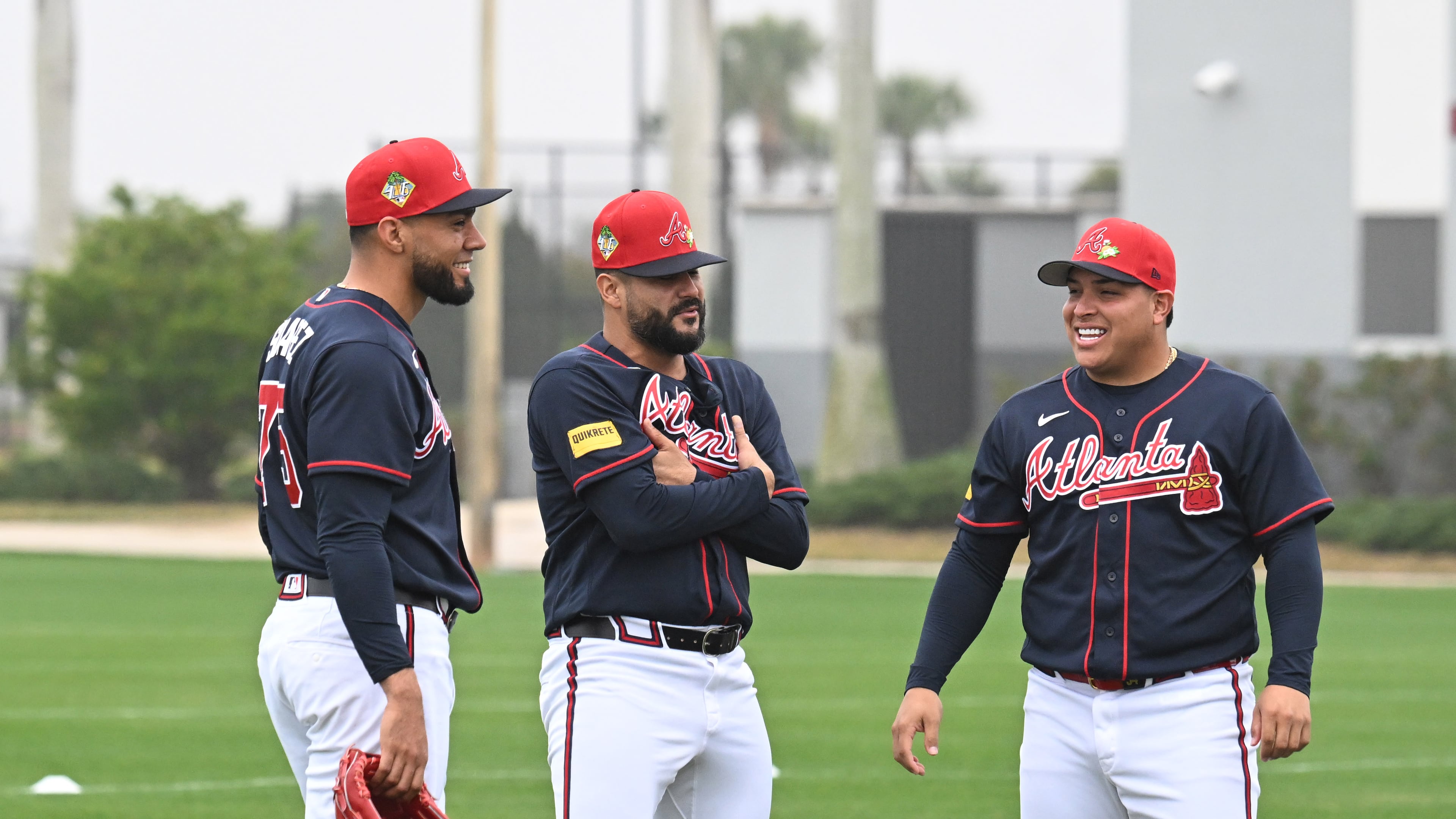 (From left) Atlanta Braves pitchers Robert Suarez, Martín Pérez and José Suarez chat during spring training workouts at CoolToday Park, Friday, Feb. 13, 2026, in North Port, Fla. (Hyosub Shin/AJC)