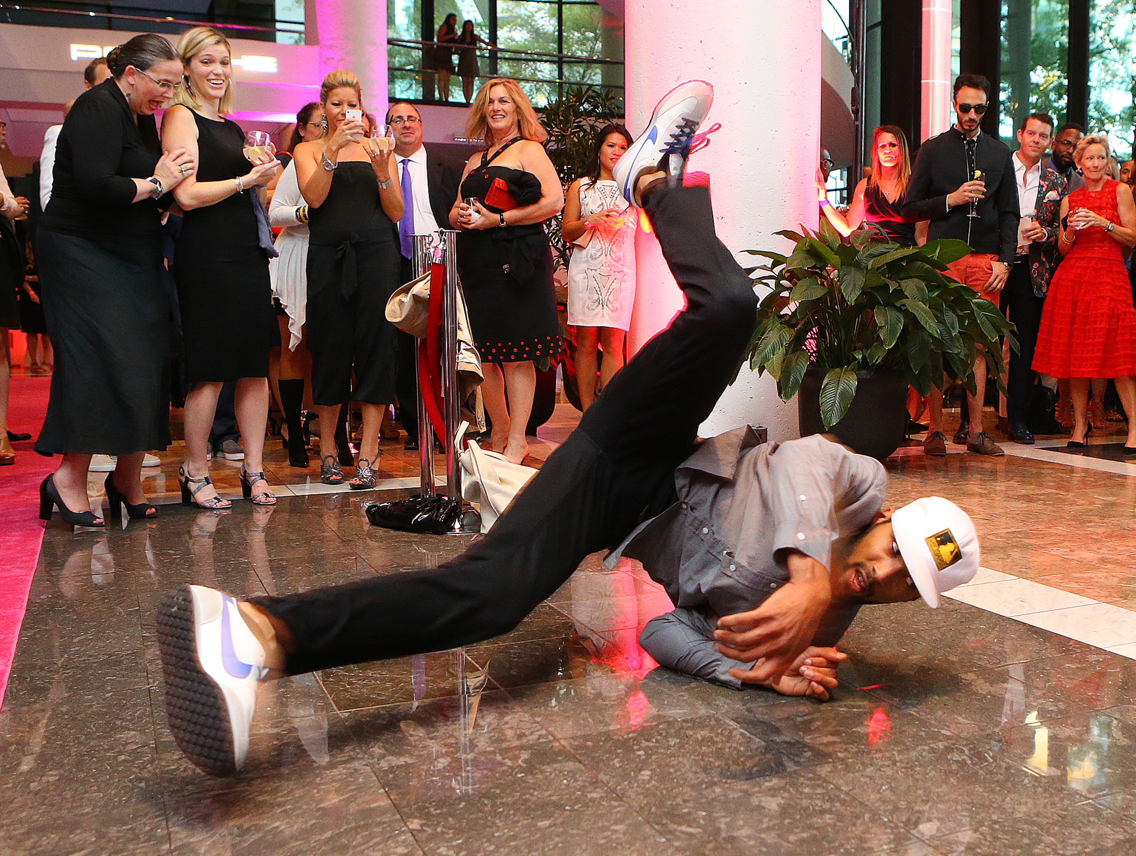 A break dancer with Rogues and Rebels performs for guests before the Jeffrey Cares Fashion Show Monday, Aug. 25, 2014, in Atlanta. The show raises awareness and funds for its beneficiaries the Susan G. Komen for the Cure Greater Atlanta Affiliate and the Atlanta AIDS Fund. CURTIS COMPTON / CCOMPTON@AJC.COM