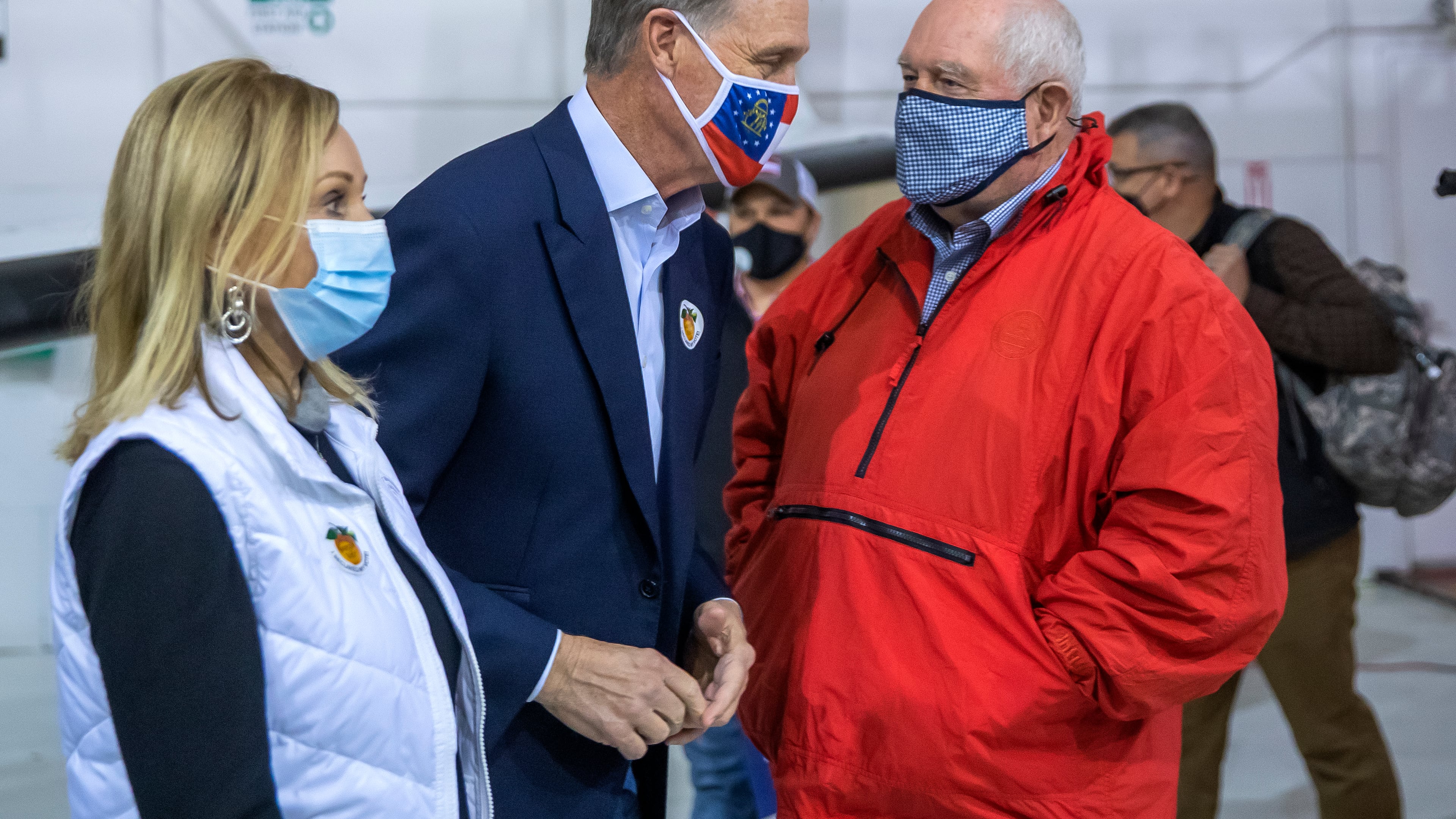 Former Republican U.S. Sen. David Perdue, center, and onetime Georgia Gov. Sonny Perdue sit on top of what has been the state's most powerful political machine. But David Perdue's challenge against Gov. Brian Kemp's bid for reelection in the May 24 GOP primary has divided some of the family's leading loyalists.