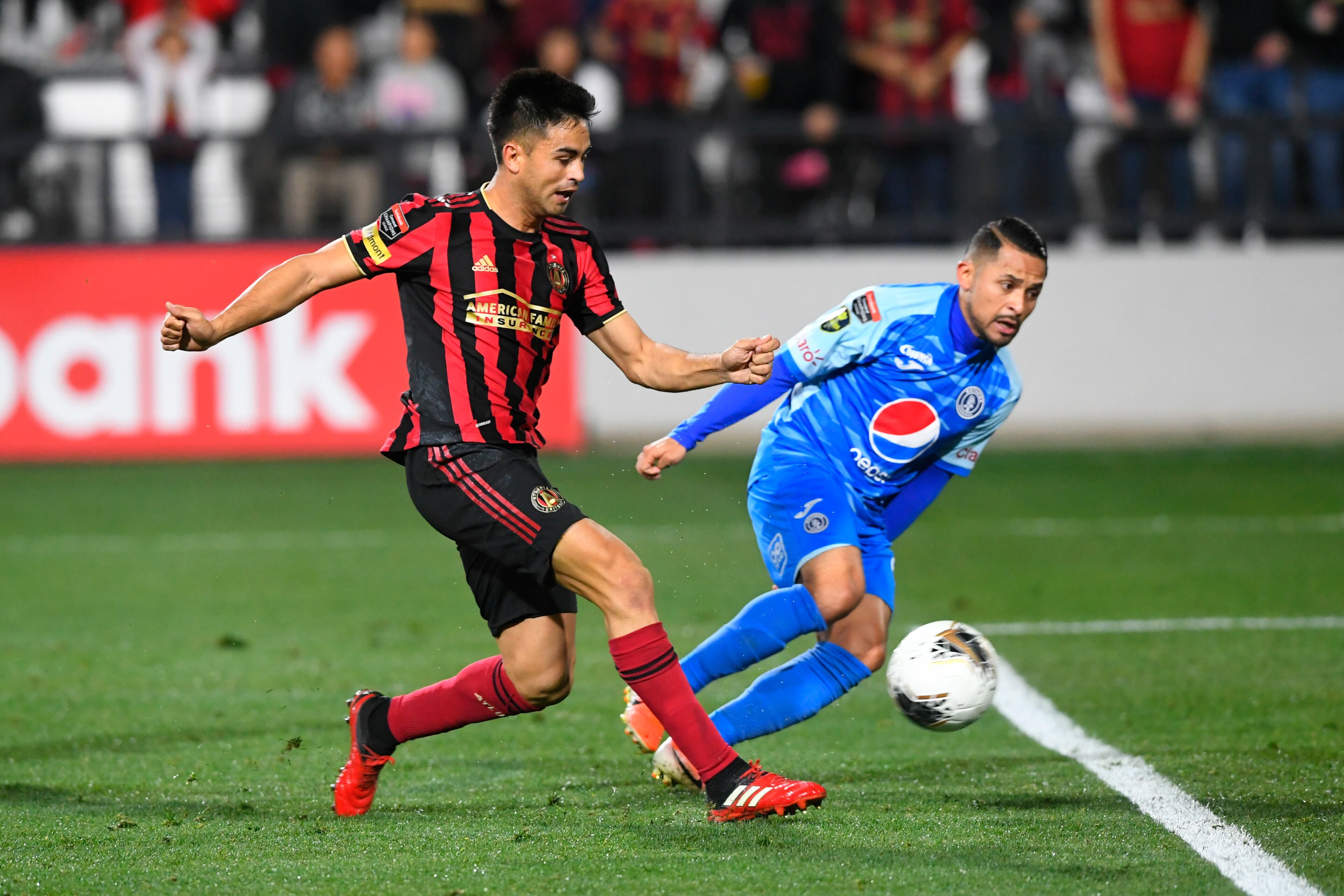 Atlanta United's Gonzalo Martinez kicks a goal as Motagua FC's Omar Elvir defends during the second half of a soccer match in the Scotiabank Concacaf Champions League, Tuesday, Feb. 25, 2020, in Kennesaw, Ga. (John Amis, Atlanta Journal Constitution)
