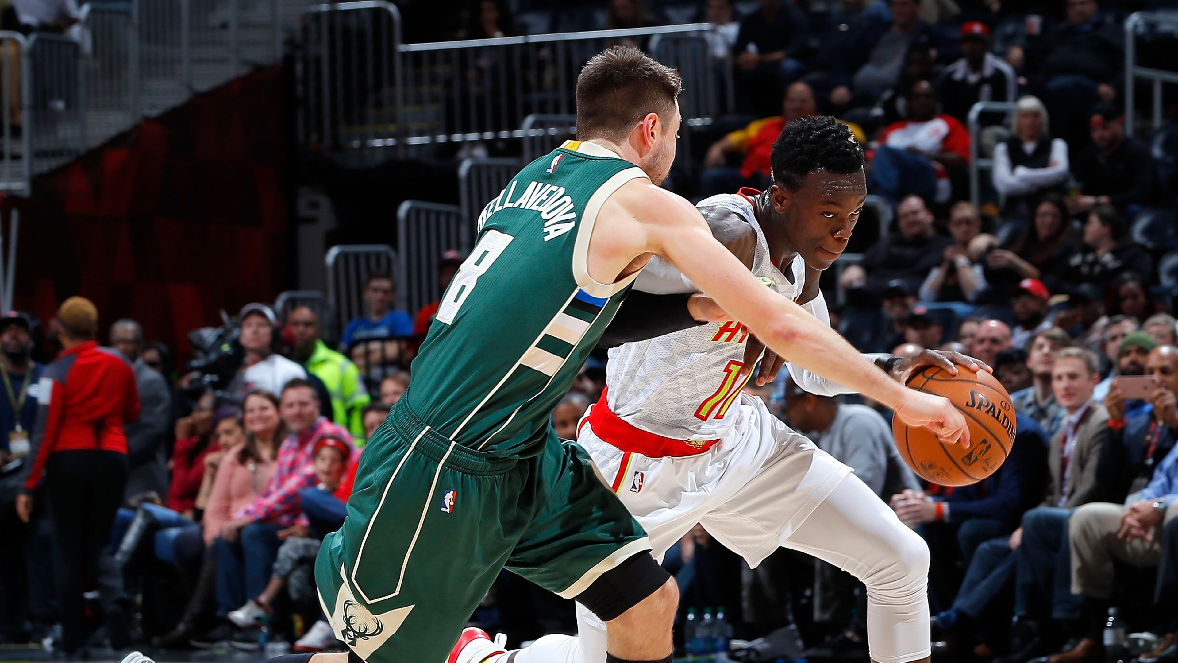 ATLANTA, GA - NOVEMBER 16: Dennis Schroder #17 of the Atlanta Hawks drives against Matthew Dellavedova #8 of the Milwaukee Bucks at Philips Arena on November 16, 2016 in Atlanta, Georgia. NOTE TO USER User expressly acknowledges and agrees that, by downloading and or using this photograph, user is consenting to the terms and conditions of the Getty Images License Agreement. (Photo by Kevin C. Cox/Getty Images)