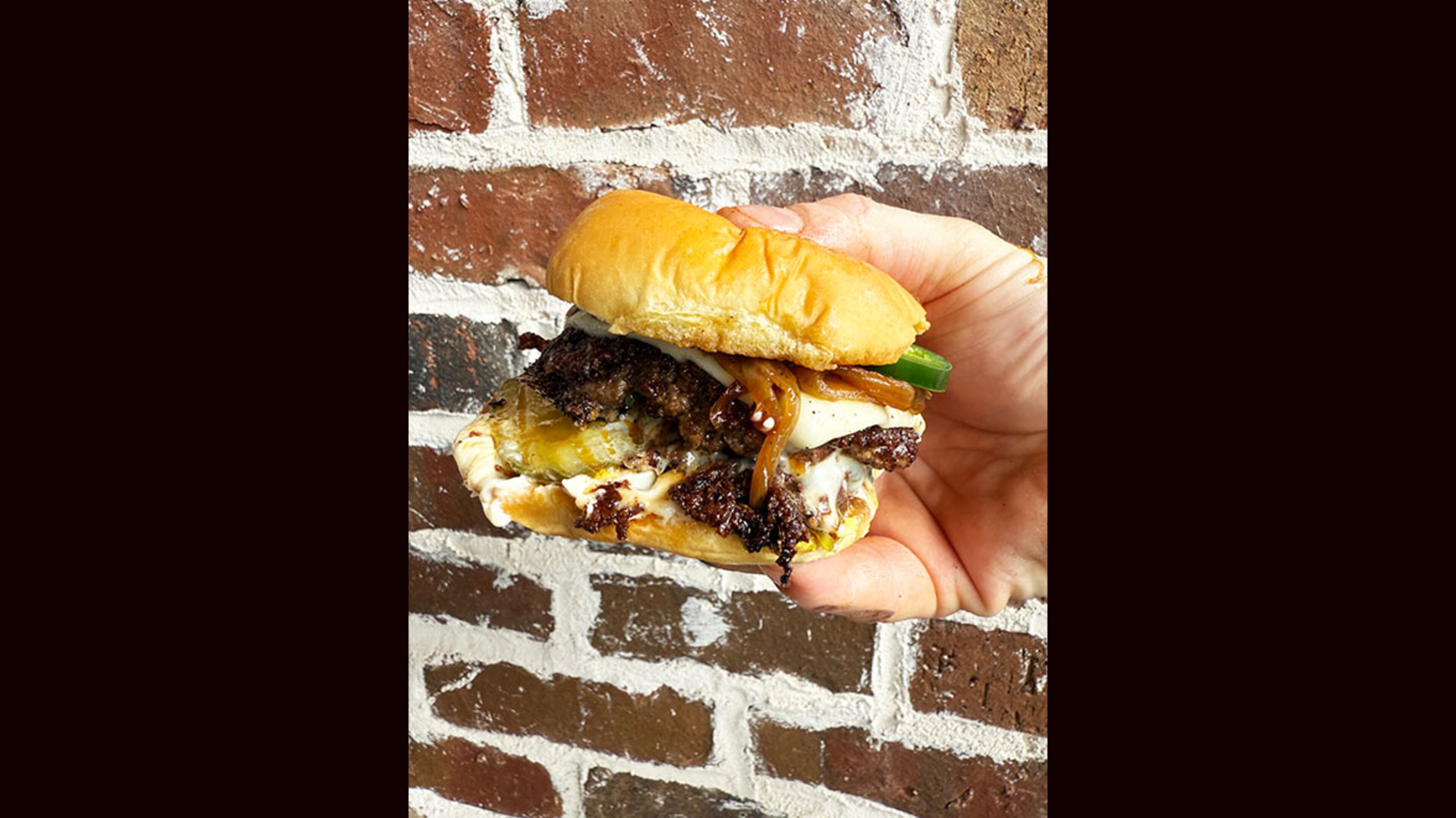 The Westside, with caramelized onion, jalapenos, garlic aioli, pickles and white American cheese is on the menu at Smash, Burgers by Vice, opening soon in Milton. (Courtesy of Nick Leahy)