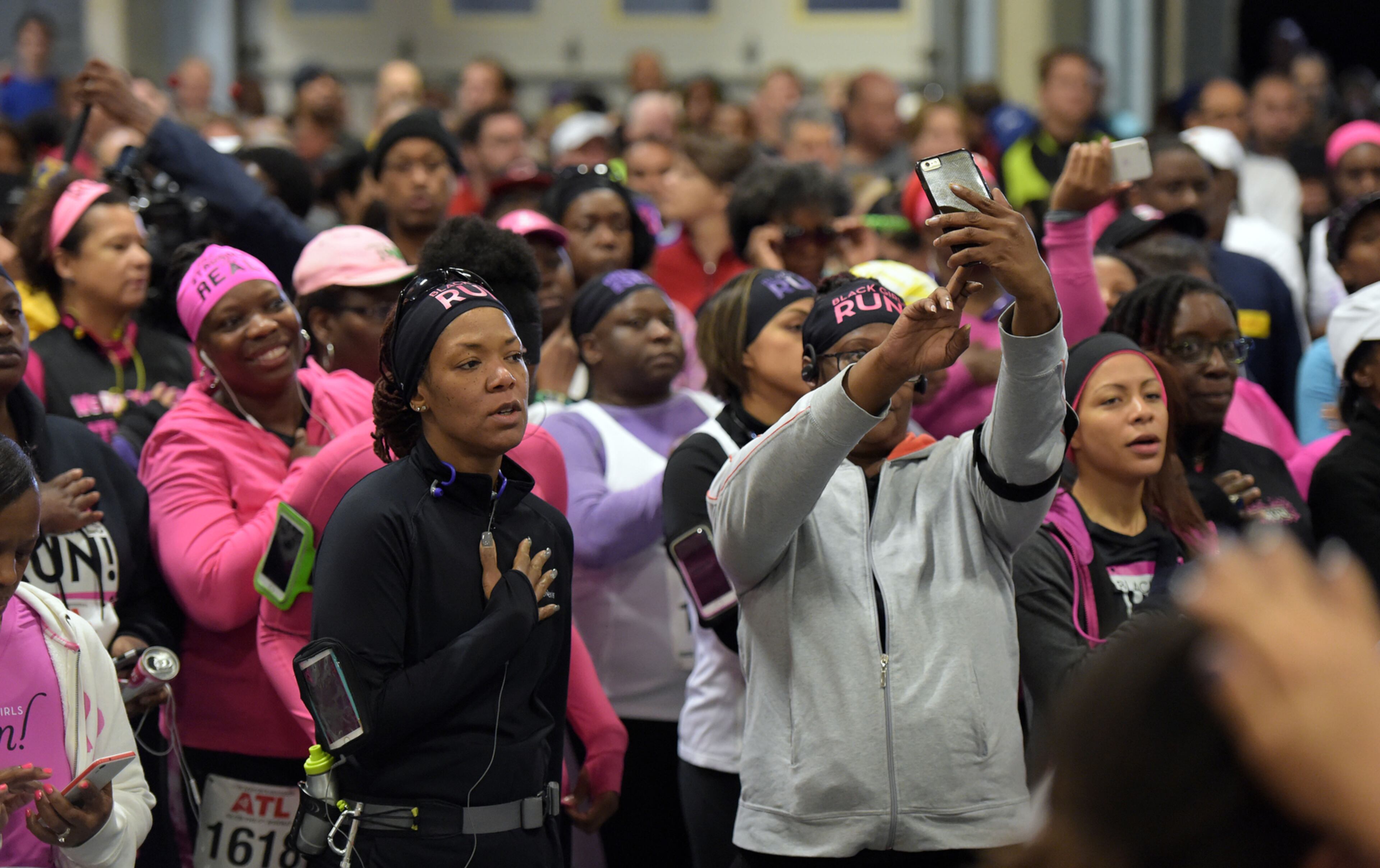 OCTOBER 17, 2015 ATLANTA Runners stand for the National Anthem inside Atlanta Fire Station #33 prior to the race. Mayor Kasim Reed and United Way President Milton Little joined more than 2,000 runners at the Mayor’s Inaugural 5K on the 5th Runway at the world’s busiest airport Saturday, October 17, 2015. Airport officials shut down the 5th runway (Runway 10/28) until 8:15 am so runners and walkers could exit the course. All proceeds from the event will benefit United Way of Greater Atlanta. Major sponsors of The Mayor’s Inaugural 5K on the 5th Runway include Delta Air Lines, The Coca-Cola Company, Enterprise Rental Car, Georgia International Convention Center, MARTA, and Publix. Over $123,000 was raised, said airport spokesman Reese McCranie. The race's overall winner was Andrew Murfee, 15, a Woodward Academy student. KENT D. JOHNSON/KDJOHNSON@AJC.COM