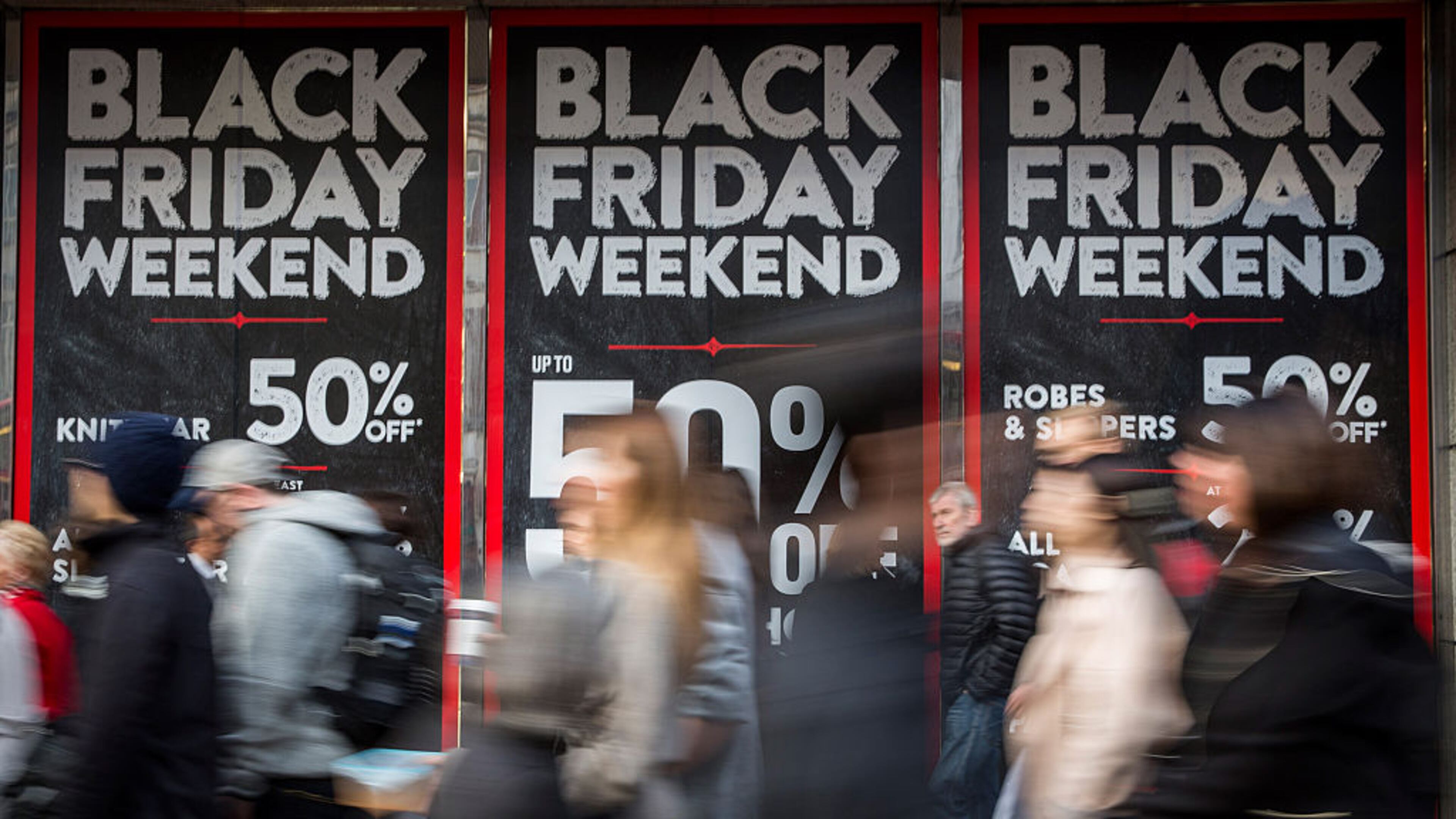 LONDON, ENGLAND - NOVEMBER 28: People walk past a shopfront on Oxford Street advertising 'Black Friday' discounts on November 28, 2014 in London, England. Originating in the USA as a sales day that following the Thanksgiving holiday, 'Black Friday' is becoming an increasingly popular shopping day in the UK. (Photo by Rob Stothard/Getty Images)
