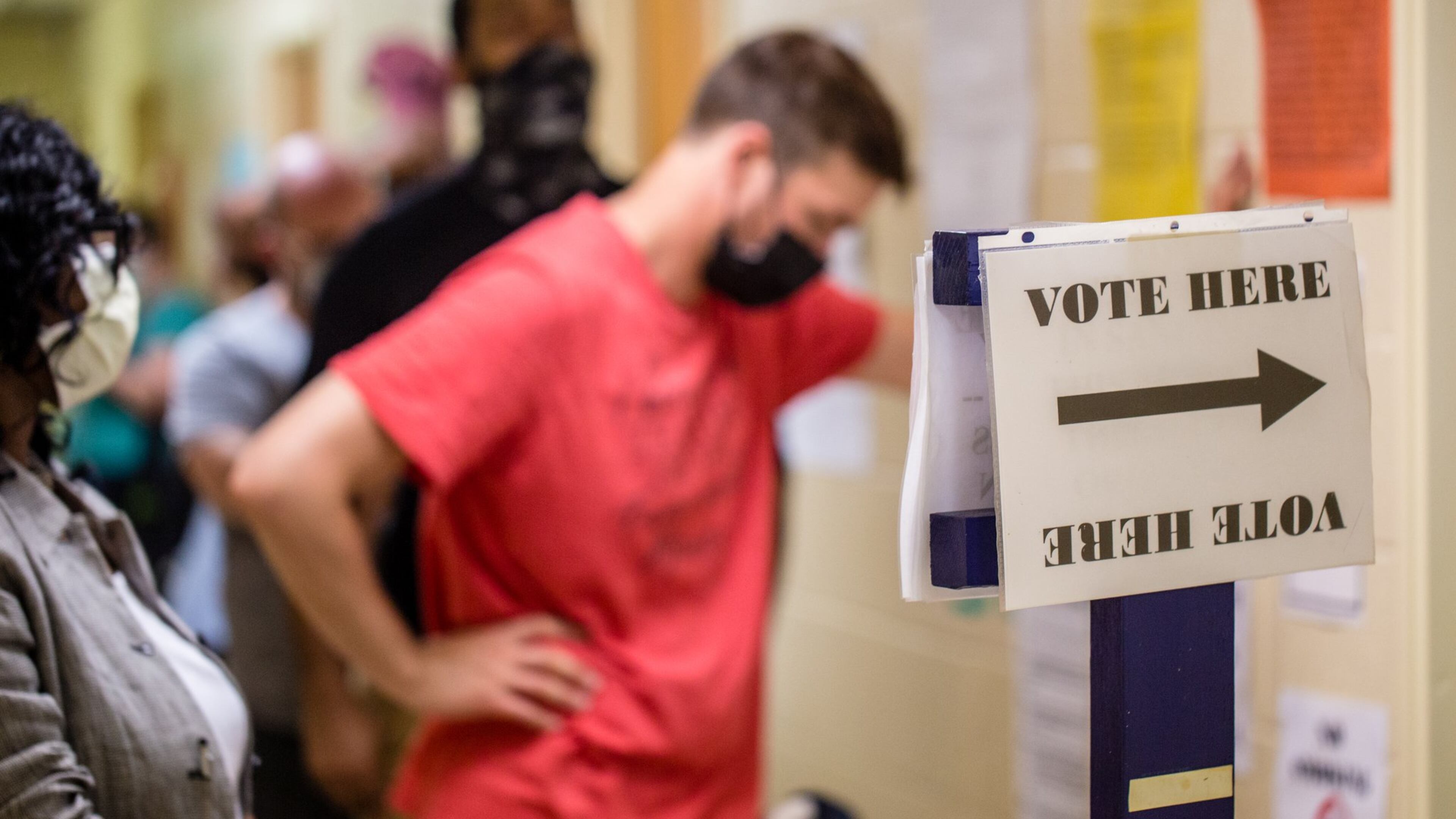 Voters waited as much as 3 1/2 hours in long lines, at times in the rain, Tuesday at New Beginnings Full Gospel Church. (Jenni Girtman for The Atlanta Journal-Constitution)