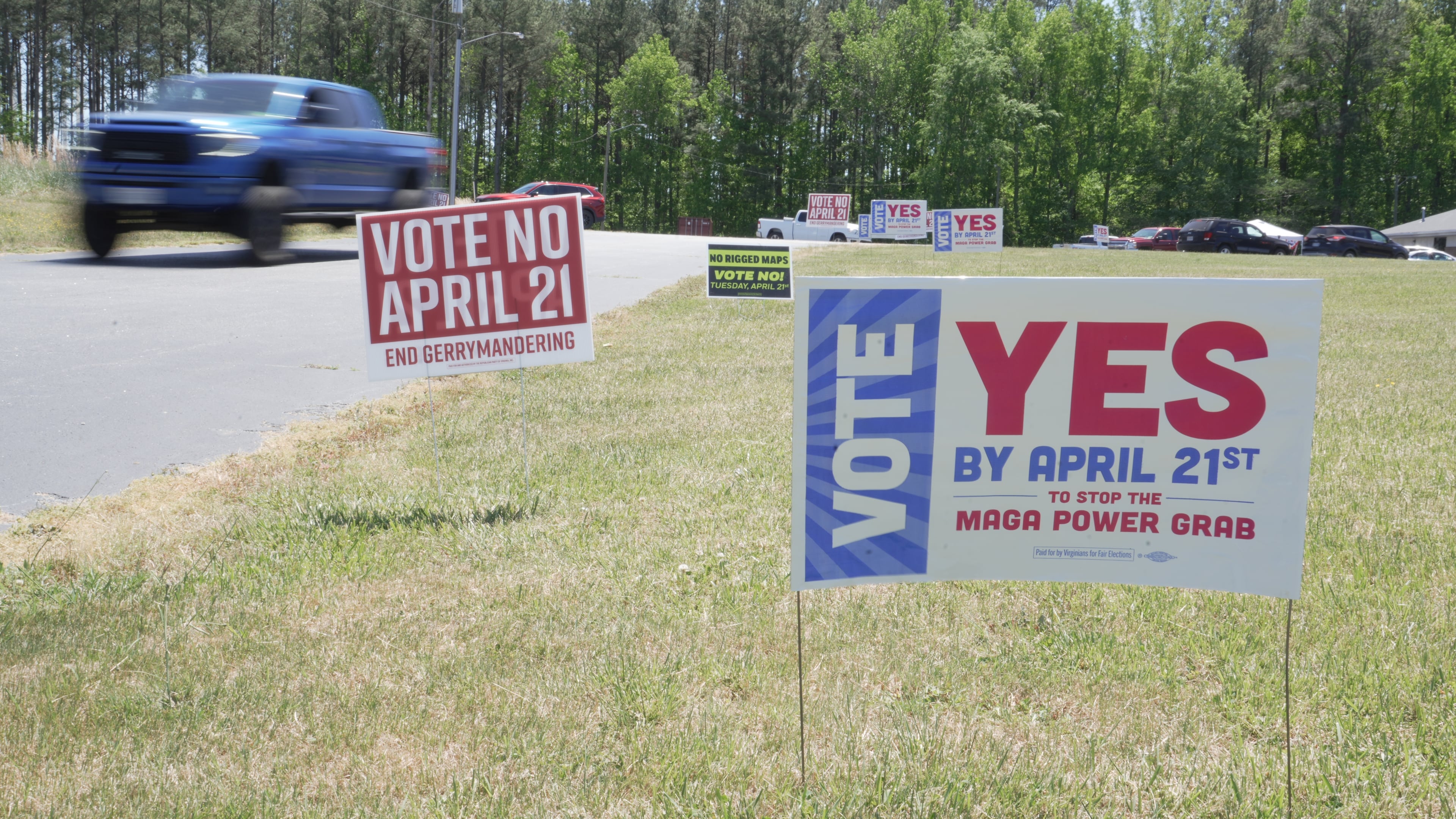 A truck passes political signs outside a polling place at Good Shepherd Catholic Church in South Hill, Va., on Tuesday, April 21, 2026. (AP Photo/Allen G. Breed)
