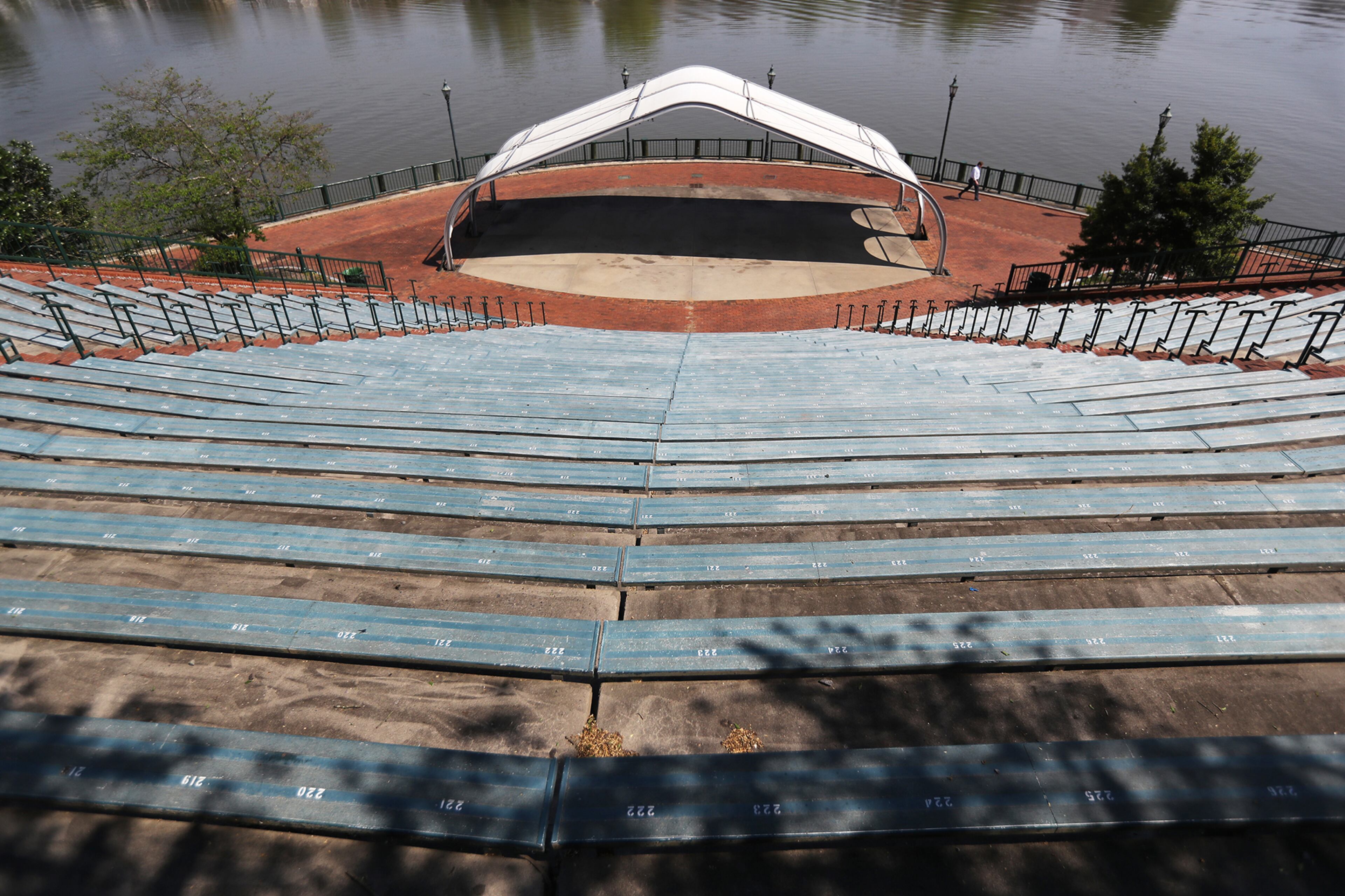 April 6, 2020 Augusta: The River Walk is ghostly quiet along the Savannah River with a lone walker passing by the amphitheatre during shelter in place on Monday, April 6, 2020, in Augusta. Curtis Compton ccompton@ajc.com