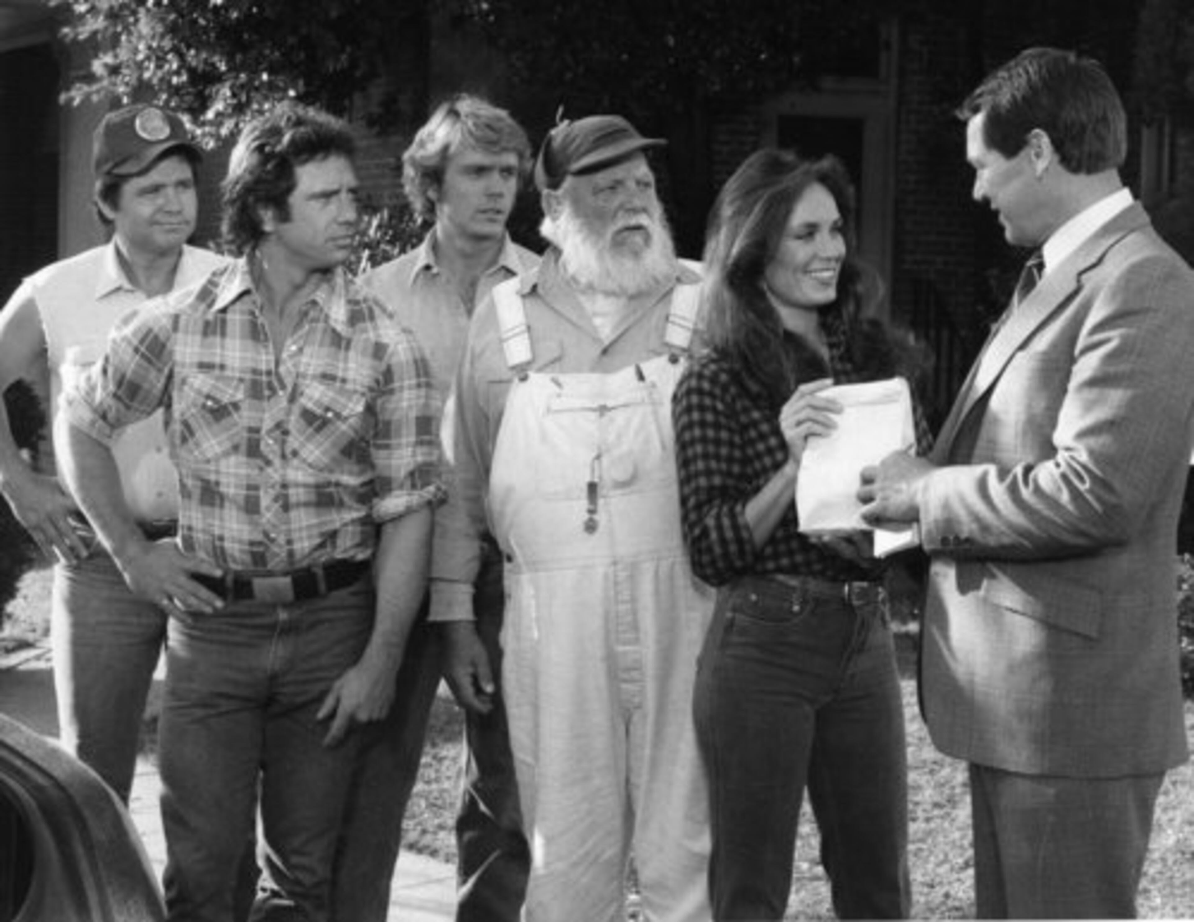 During the early 1980s, CBS' "The Dukes of Hazzard" was among the most popular series on television. The series will be feted this weekend during 'Dukesfest' at the Atlanta Motor Speedway. From left, the show's original cast members Ben Jones, Tom Wopat, John Schneider, Denver Pyle, Catherine Bach deal with a crooked cop played by Sonny Shroyer during an episode.