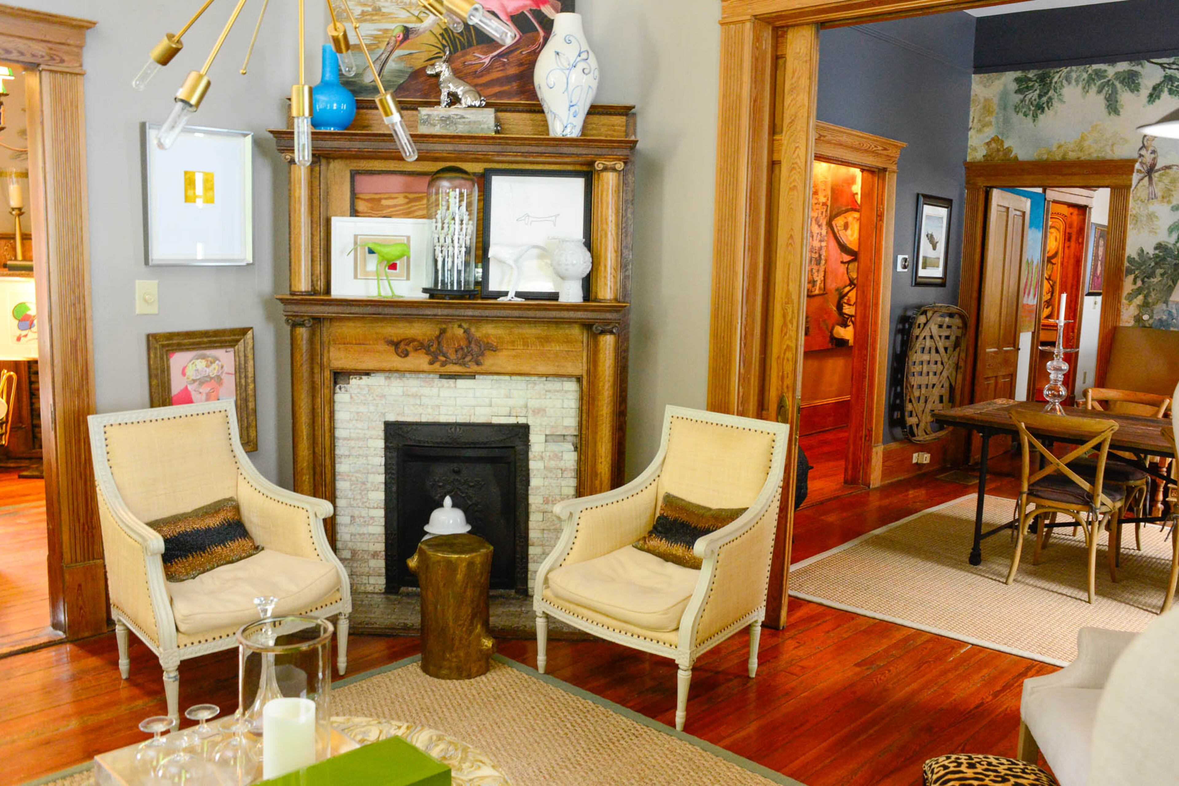 When Brad Resler found the nailhead-trim chairs on clearance at Ballard Design years ago, he snatched them up. Today, the chairs are nestled around a tin-covered table shaped like a log in his Grant Park living room. The fireplace is original to the home and is even missing some tiles, which Resler said he likes. "I don't like things really perfect. I like it to show some age and some use," he said.