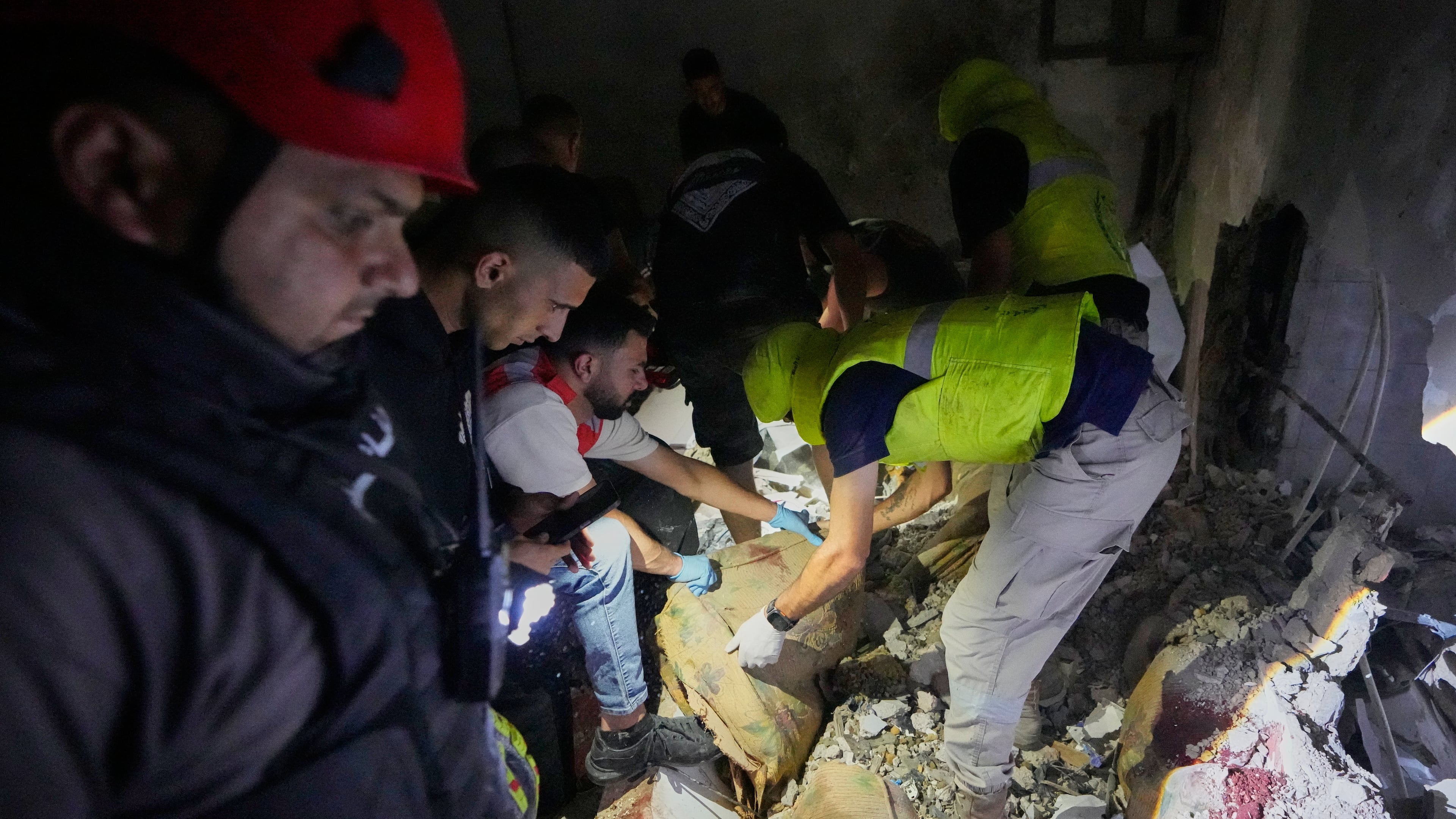Rescue workers search for victims inside a destroyed apartment that was hit in an Israeli airstrike in the southern port city of Sidon, Lebanon, Thursday, May 28, 2026. (AP Photo/Mohammed Zaatari)
