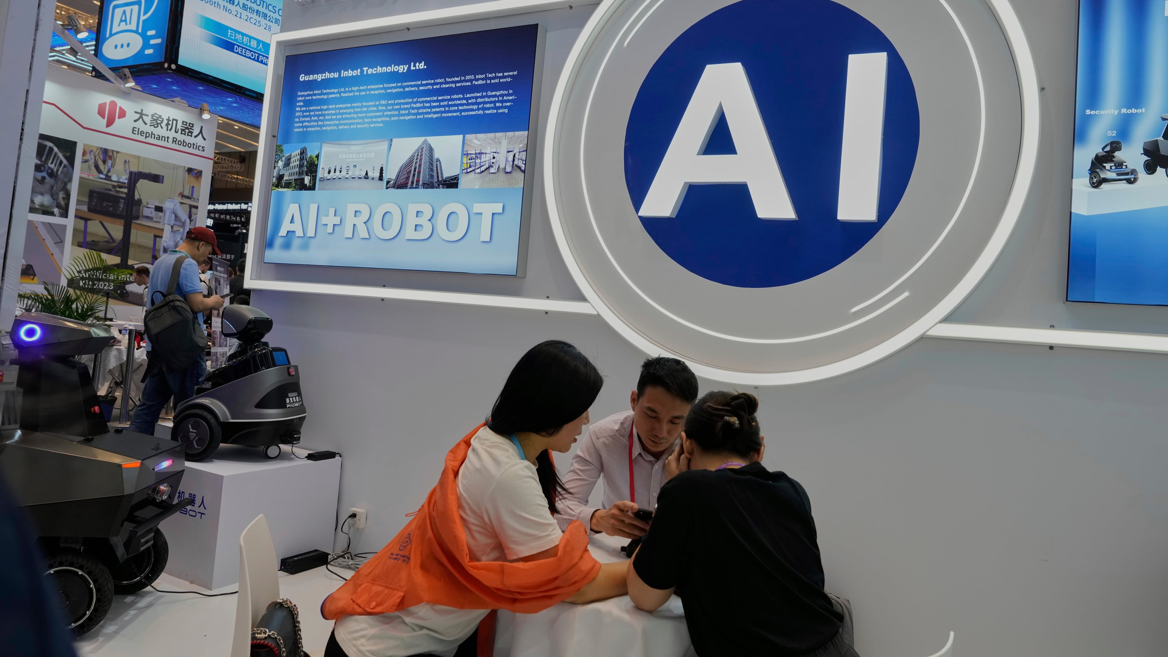 FILE -Vendors for AI enabled robots wait for customers at the 137th Canton Fair in Guangzhou in southern China's Guangdong province on April 16, 2025. (AP Photo/Ng Han Guan, File)
