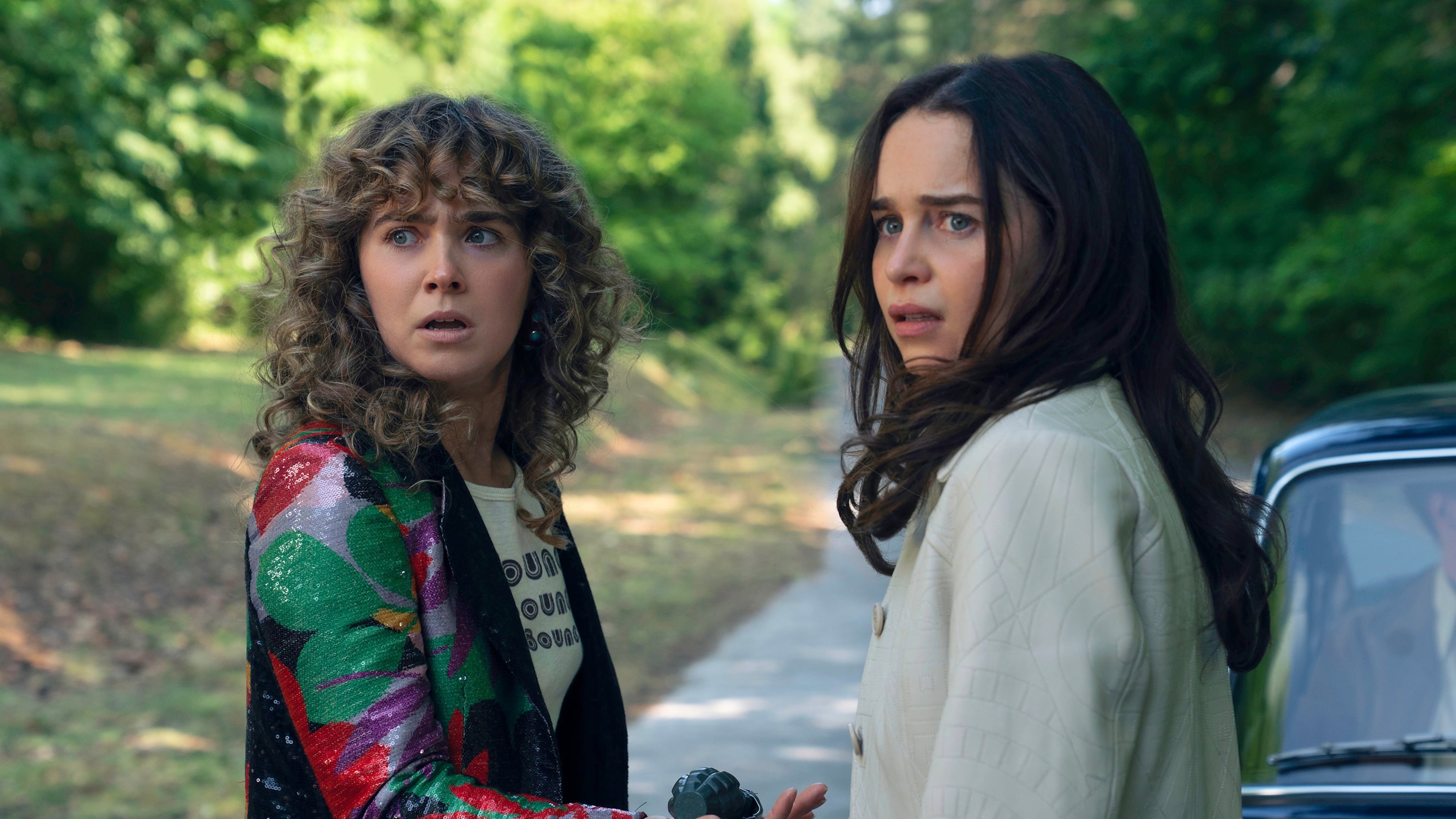 This image released by Peacock shows Haley Lu Richardson, left, and Emilia Clarke in a scene from "Ponies." (Katalin Vermes/Peacock via AP)