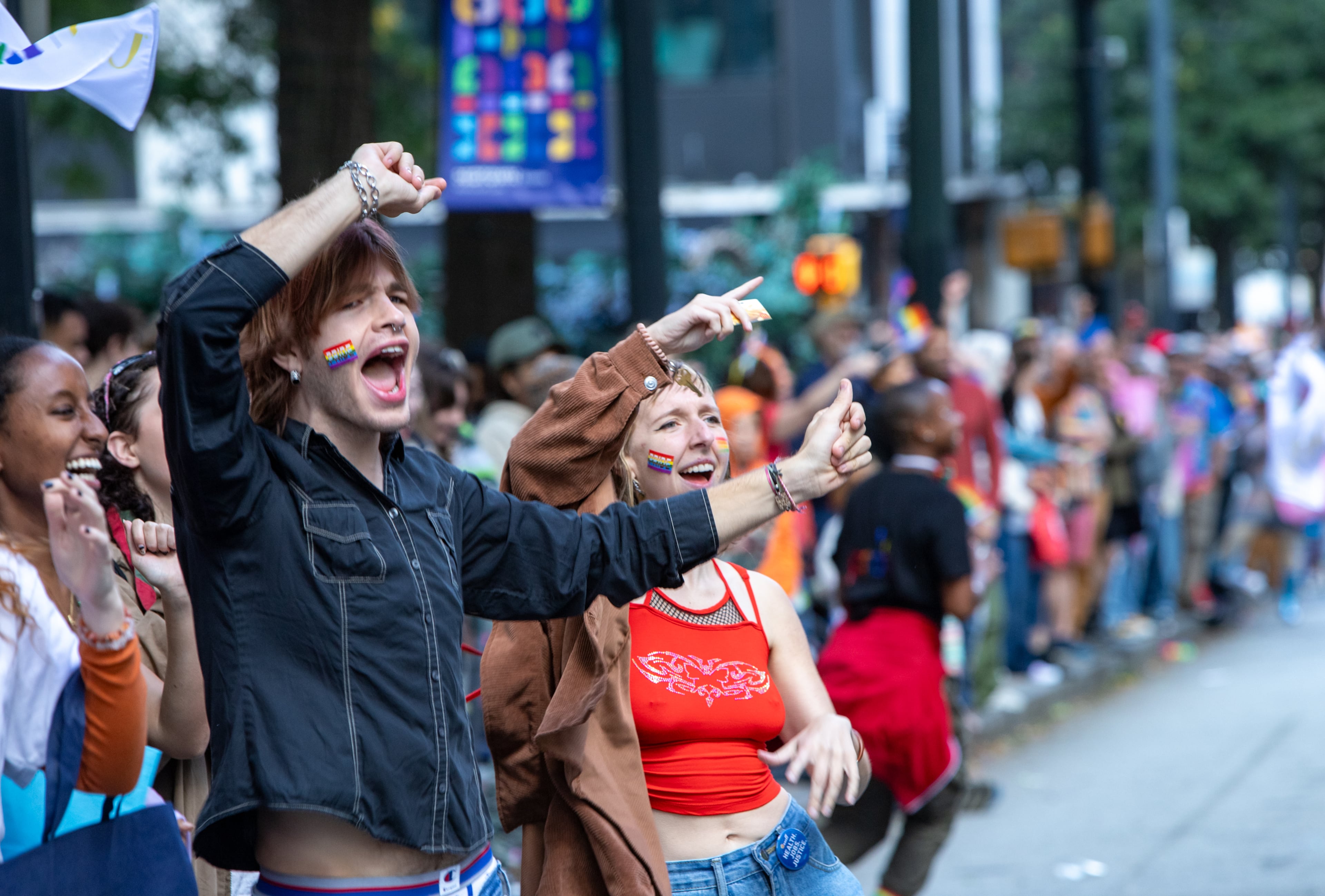 Santiago Pollitzer, from left, and Helen Foster participate in the annual Pride Parade as it runs up Peachtree Street in Atlanta on Sunday, Oct 15, 2023. (Jenni Girtman for The Atlanta Journal-Constitution)