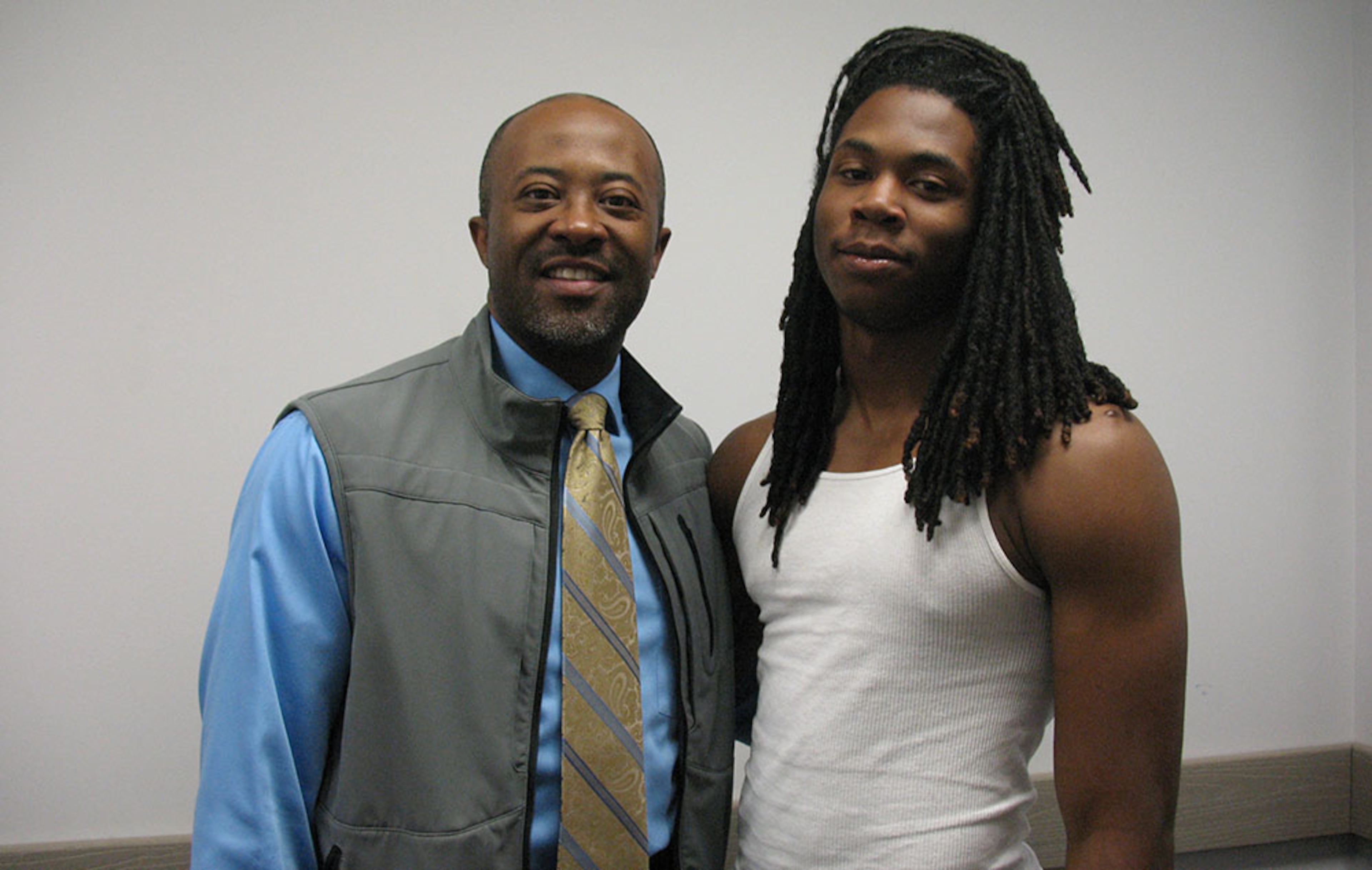Corey Wimberly (l) was instrumental in getting Briscoe back on a straight and narrow path. A detective in the St. Charles Sherriff's Office and rec-league football coach, Wimberly served as a mentor for Briscoe and helped him navigate the recruiting chaos that eventually came his way. (AJC / CHIP TOWERS)