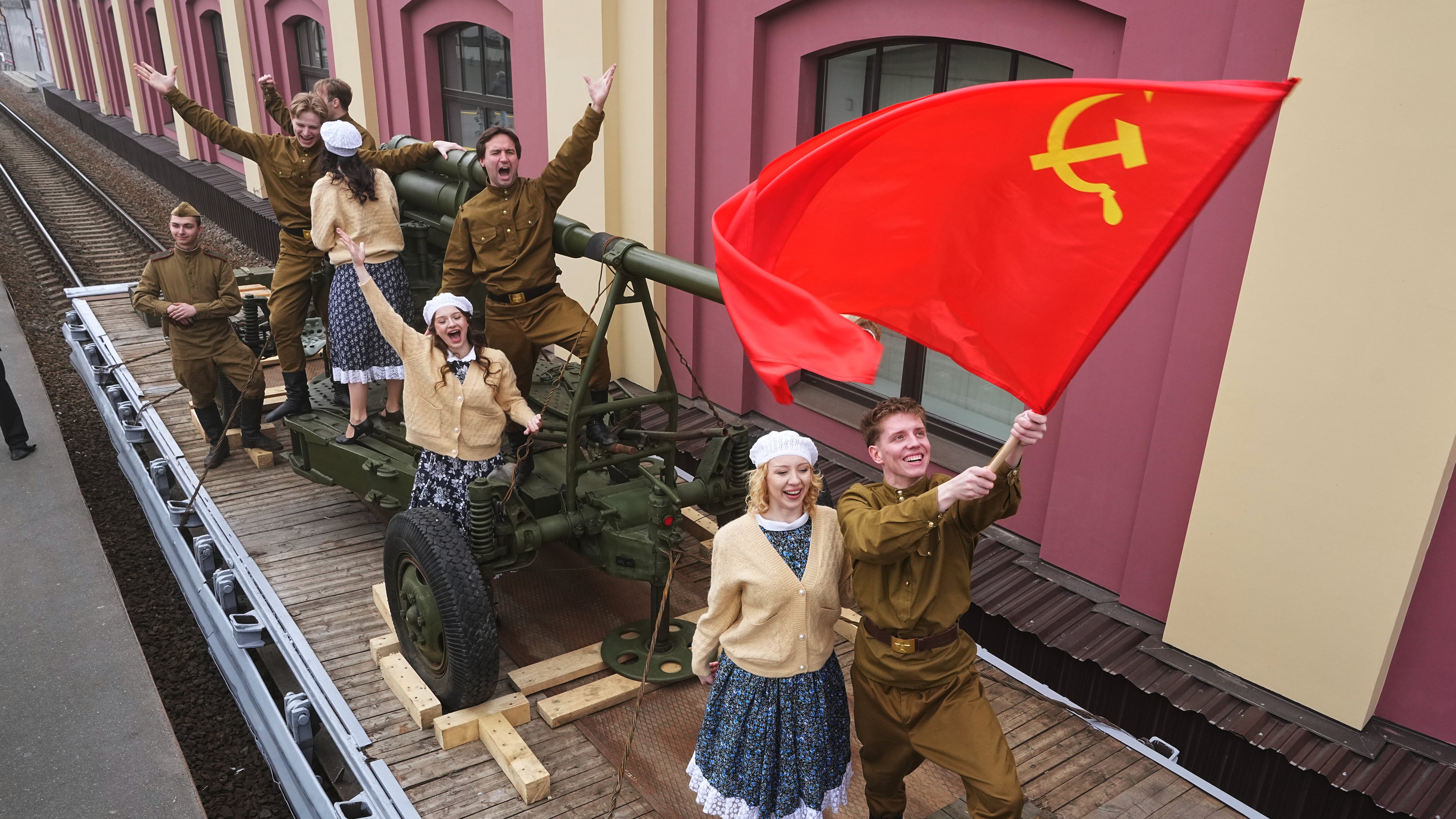 Actors attend a historical reenactment depicting the arrival of trains after the end of the war as a part of celebrations ahead of the 81st anniversary of the Soviet Union's victory over Nazi Germany during World War II, at the Baltiysky railway station in St. Petersburg, Russia, Thursday, May 7, 2026. (AP Photo/Dmitri Lovetsky)