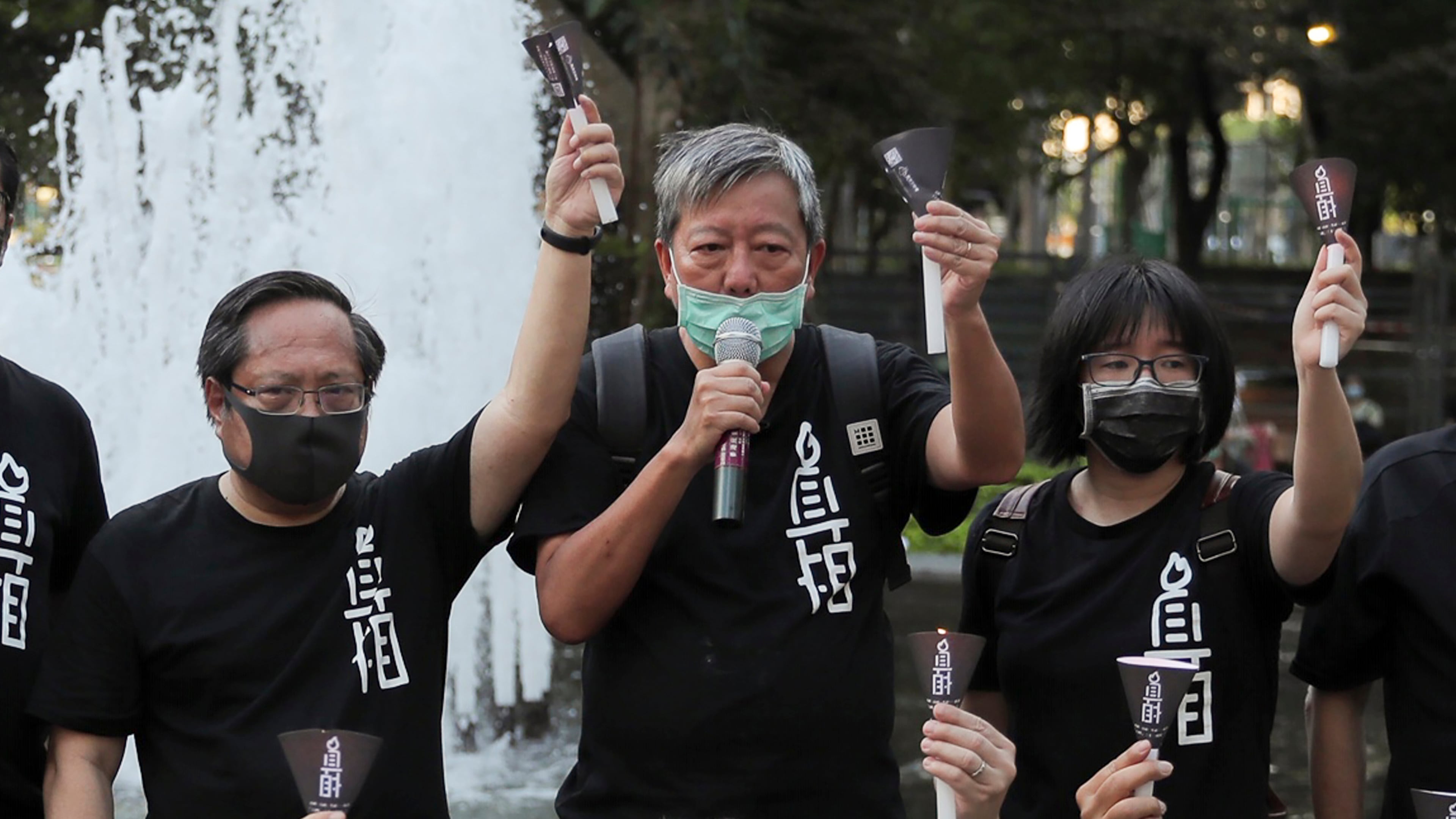 FILE - Pro-democracy activists including from left Albert Ho, Lee Cheuk-yan and Chow Hang-tung shout slogans during a gathering to mourn those killed in the 1989 Tiananmen crackdown at Victoria Park in Causeway Bay, Hong Kong on June 4, 2020. (AP Photo/Kin Cheung, File)