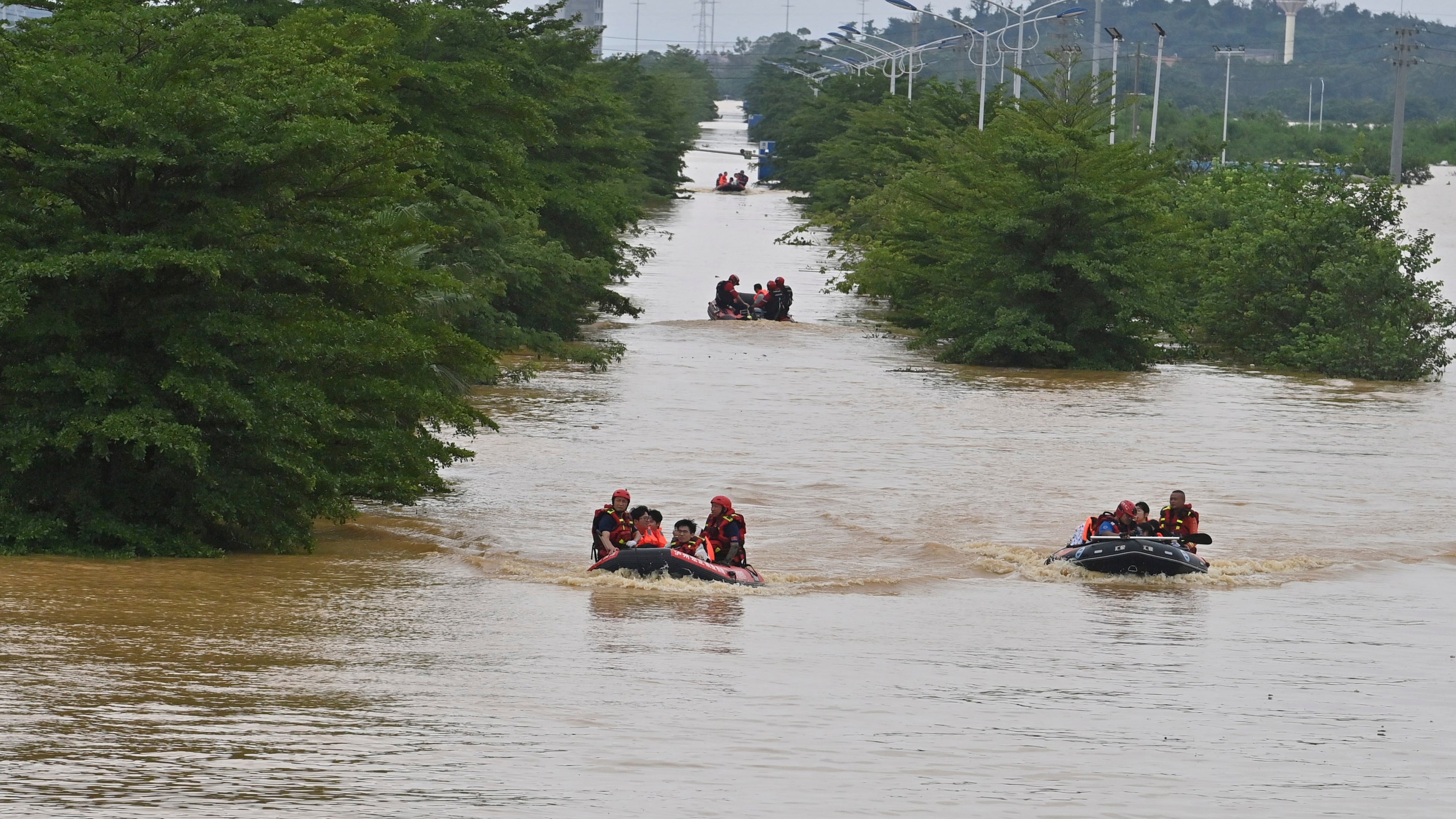 In this photo released by Xinhua News Agency, rescuers evacuate stranded teachers and students at Xijiang education park in the aftermath of tropical storm Maysak in Guigang City, south China's Guangxi Zhuang Autonomous Region, July 8, 2026. (Zhou Hua/Xinhua via AP)