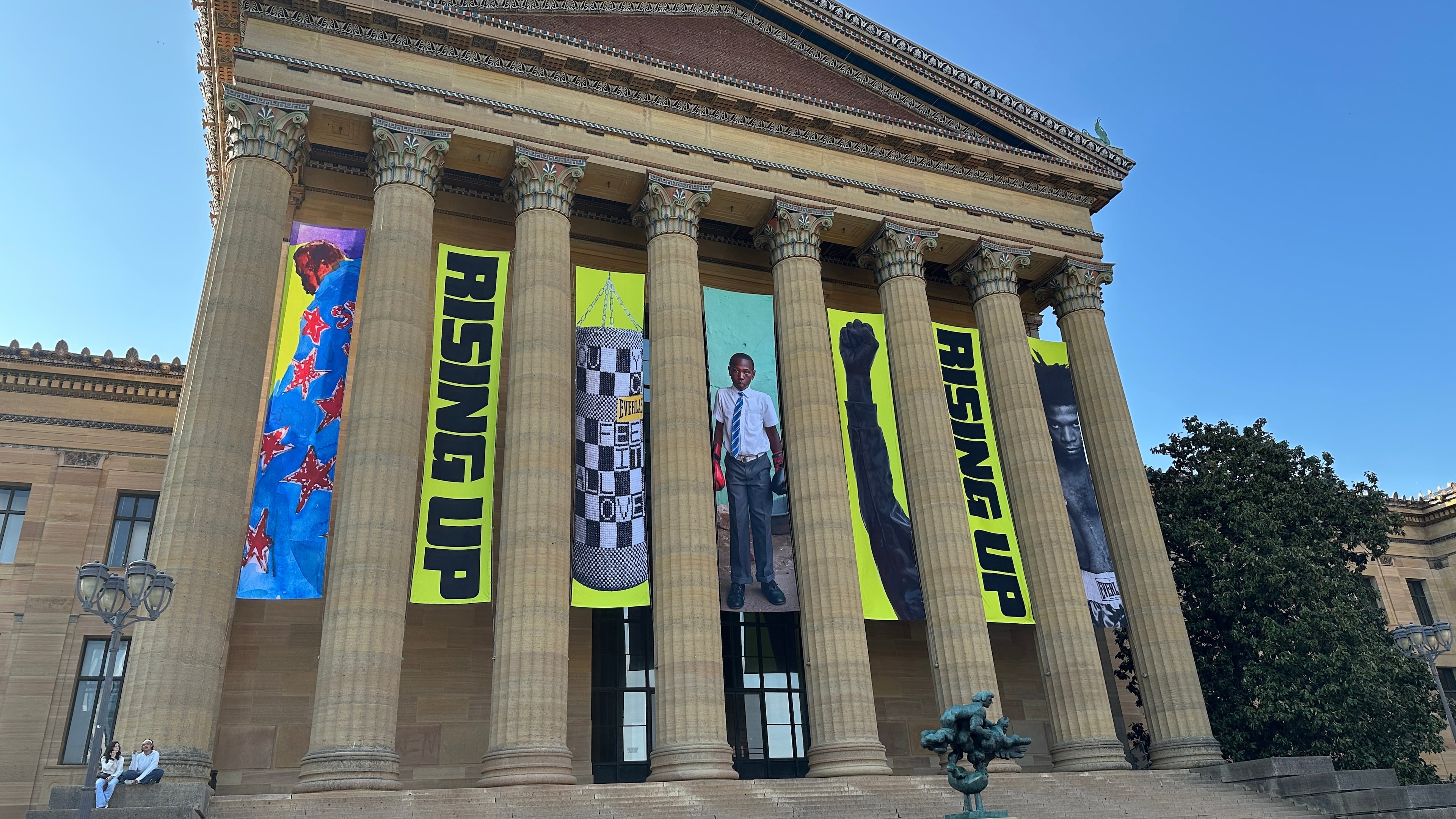 Banners for the "Rising Up: Rocky" exhibition hang outside of the Philadelphia Museum of Art in Philadelphia, Wednesday, April 22, 2026. (AP Photo/Tassanee Vejpongsa)