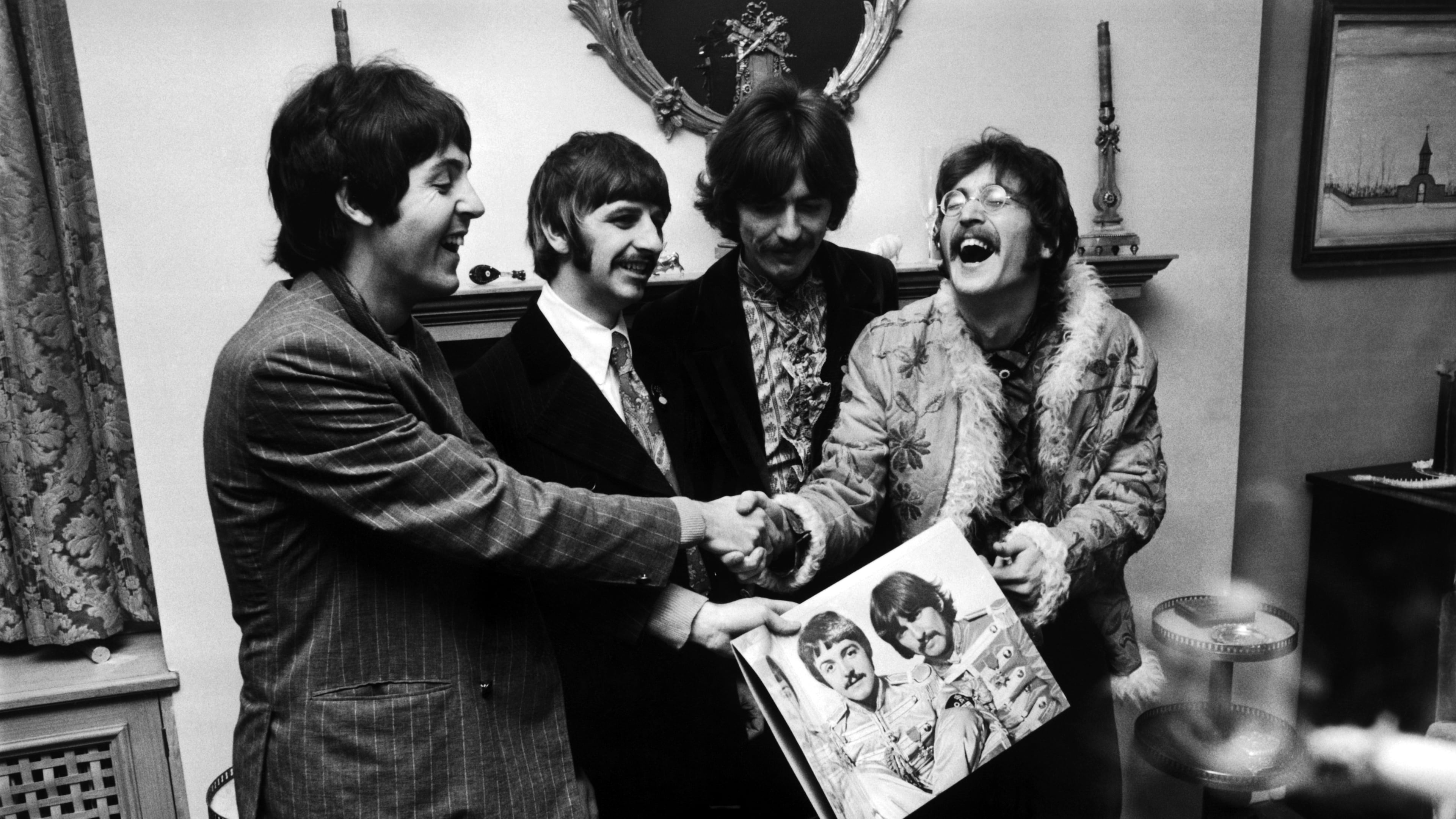 The Beatles (left to right) George Harrison, Ringo Starr, John Lennon and Paul McCartney, hold the sleeve of "Sgt. Pepper's Lonely Hearts Club Band," at the press launch for the album, held at Brian Epstein's house on May 19, 1967.