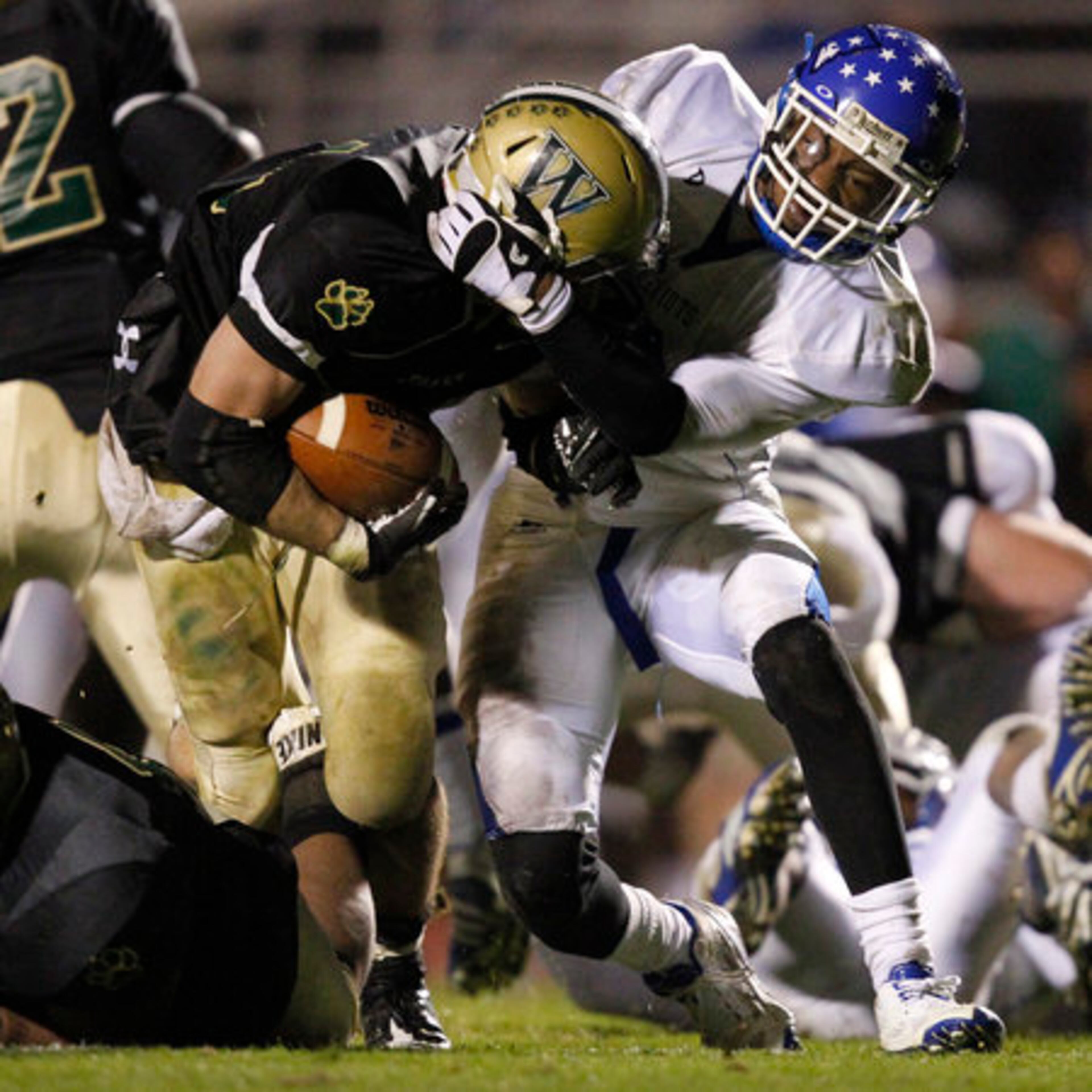 Wesleyan's Kyle Karempelis (24) gets tackled by the helmet by a Wilcox County defender during the second half.