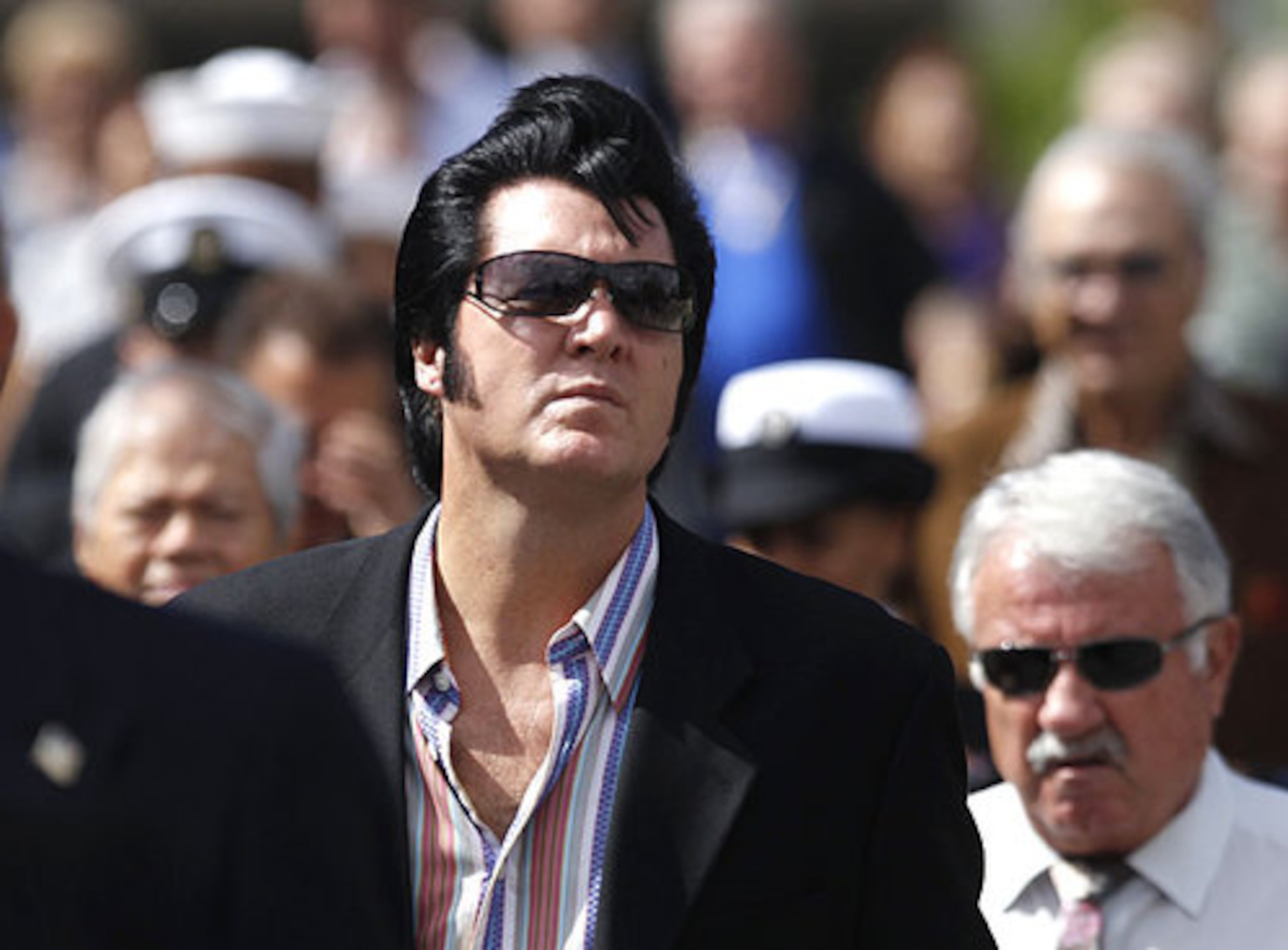 Fans of Tony Curtis walk to his burial service.