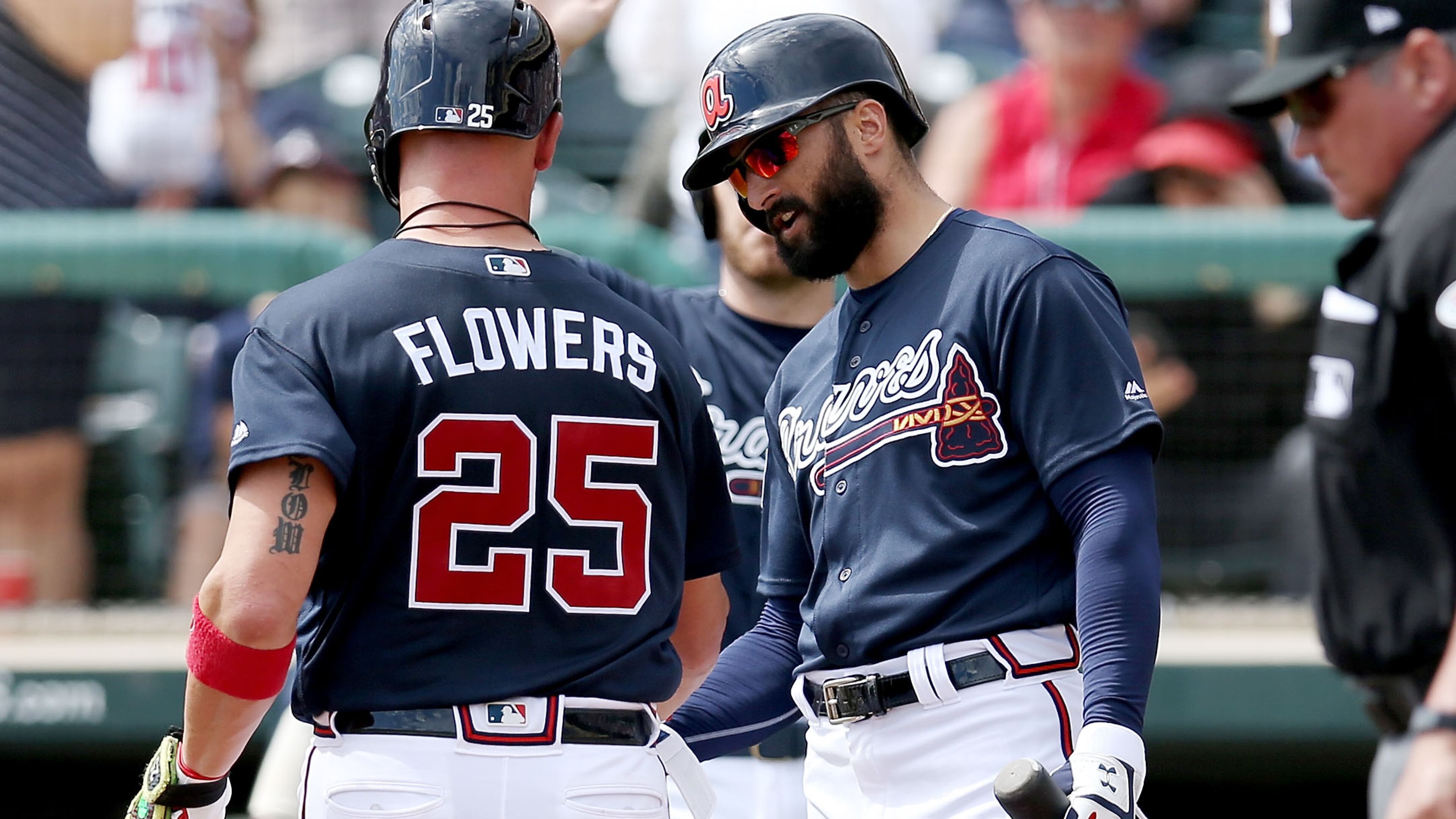 Braves' Tyler Flowers and Nick Markakis (right) celebrate after Flowers hit a home run in the first inning Sunday, March 3, 2019, against the Miami Marlins at Champion Stadium in Lake Buena Vista, Fla.