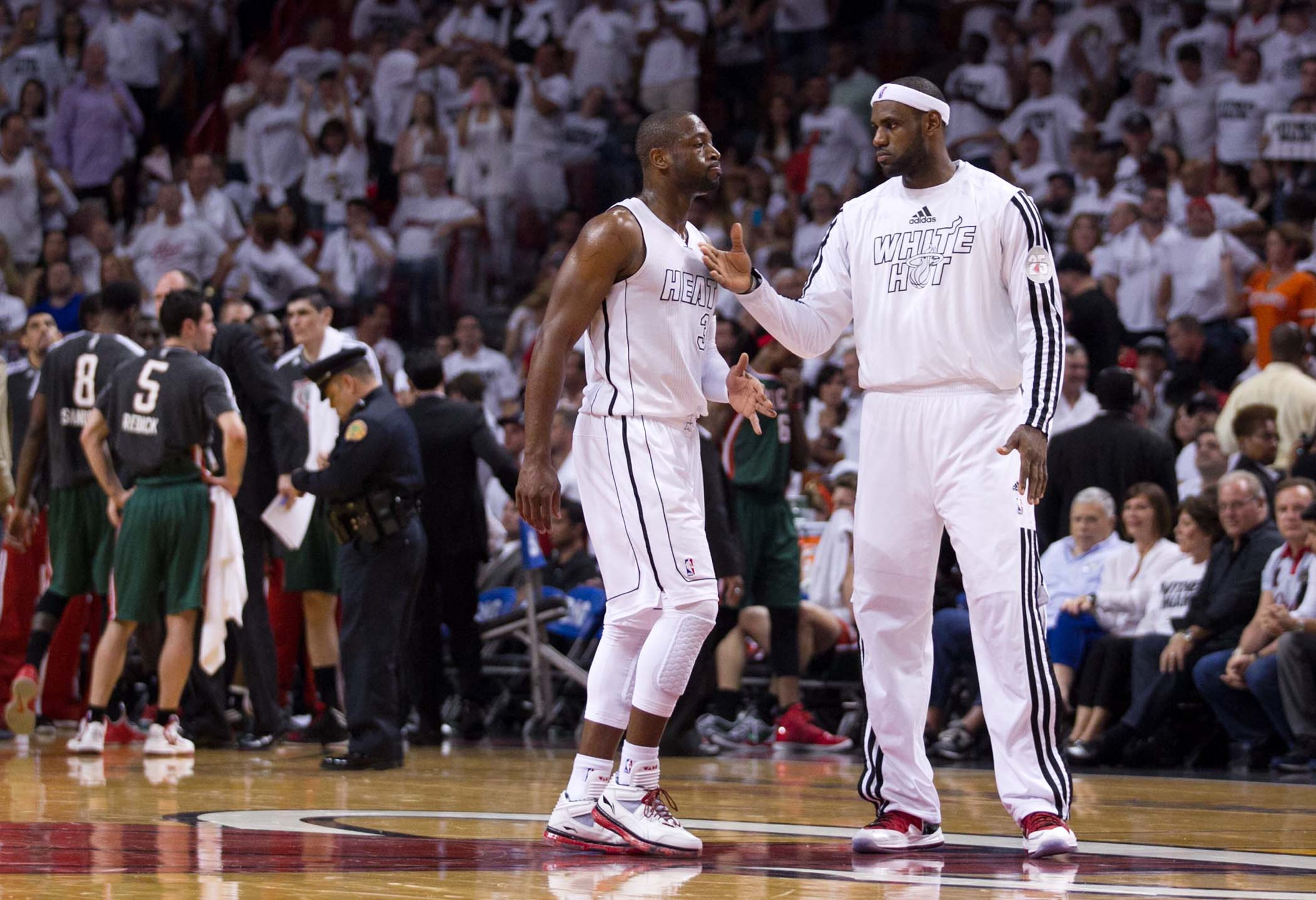 Miami Heat shooting guard Dwyane Wade (3) and Miami Heat small forward LeBron James (6) head to the bench drink a timeout at AmericanAirlines Arena on April 21, 2013. (Allen Eyestone/The Palm Beach Post)