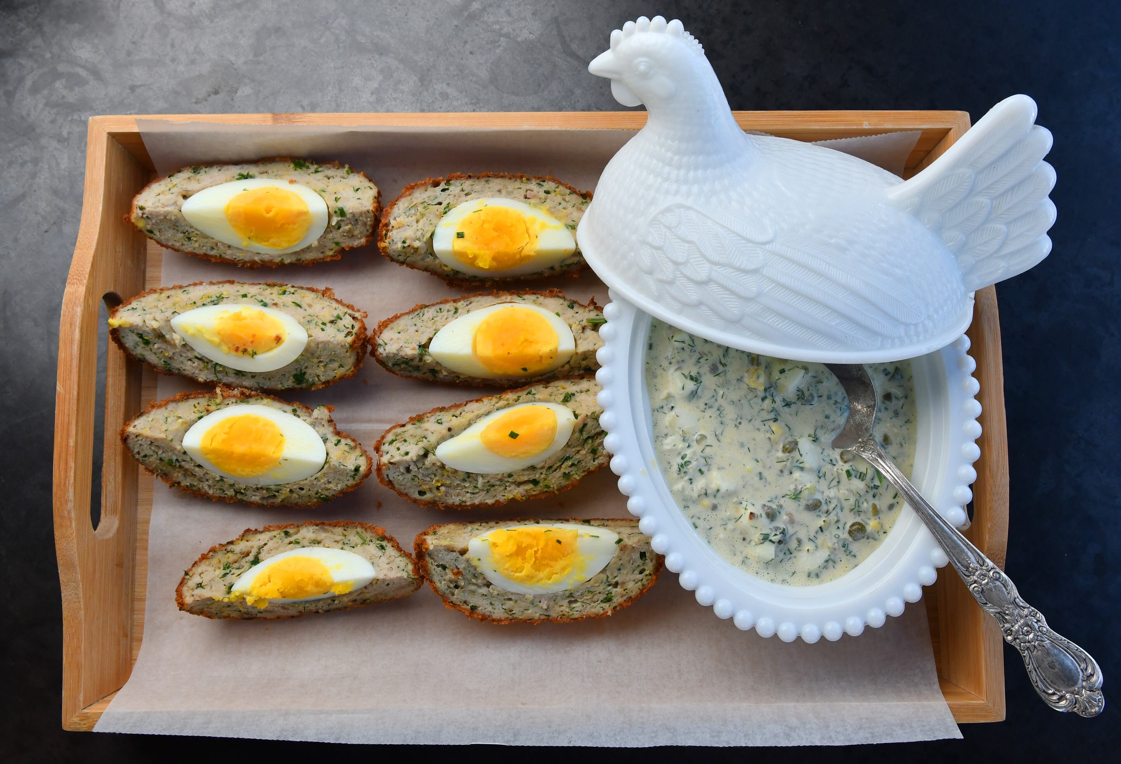 The "Atlanta" Egg, a variation on the Scotch egg, is from Biggerstaff Brewing Company executive chef Davis King. It's made with chicken sausage instead of pork, and it's served with Gribiche sauce. (Styling by executive chef Davis King / Chris Hunt for the AJC)