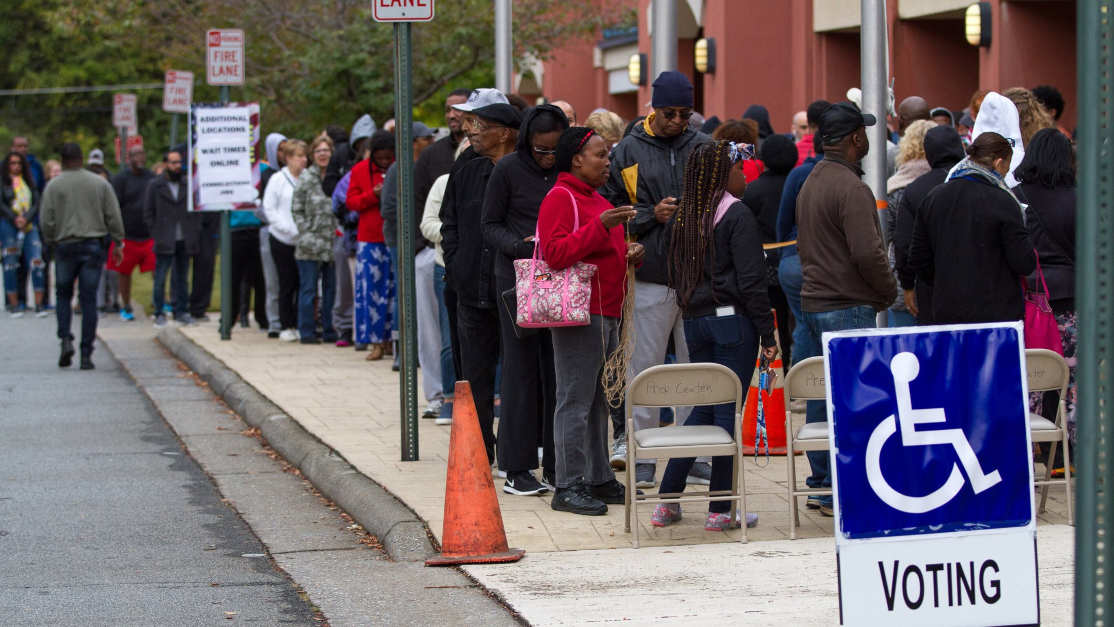 People wait in a long line to vote on Saturday, Oct. 27, 2018, at the Cobb County Board of Elections and Registration office in Marietta. STEVE SCHAEFER / SPECIAL TO THE AJC