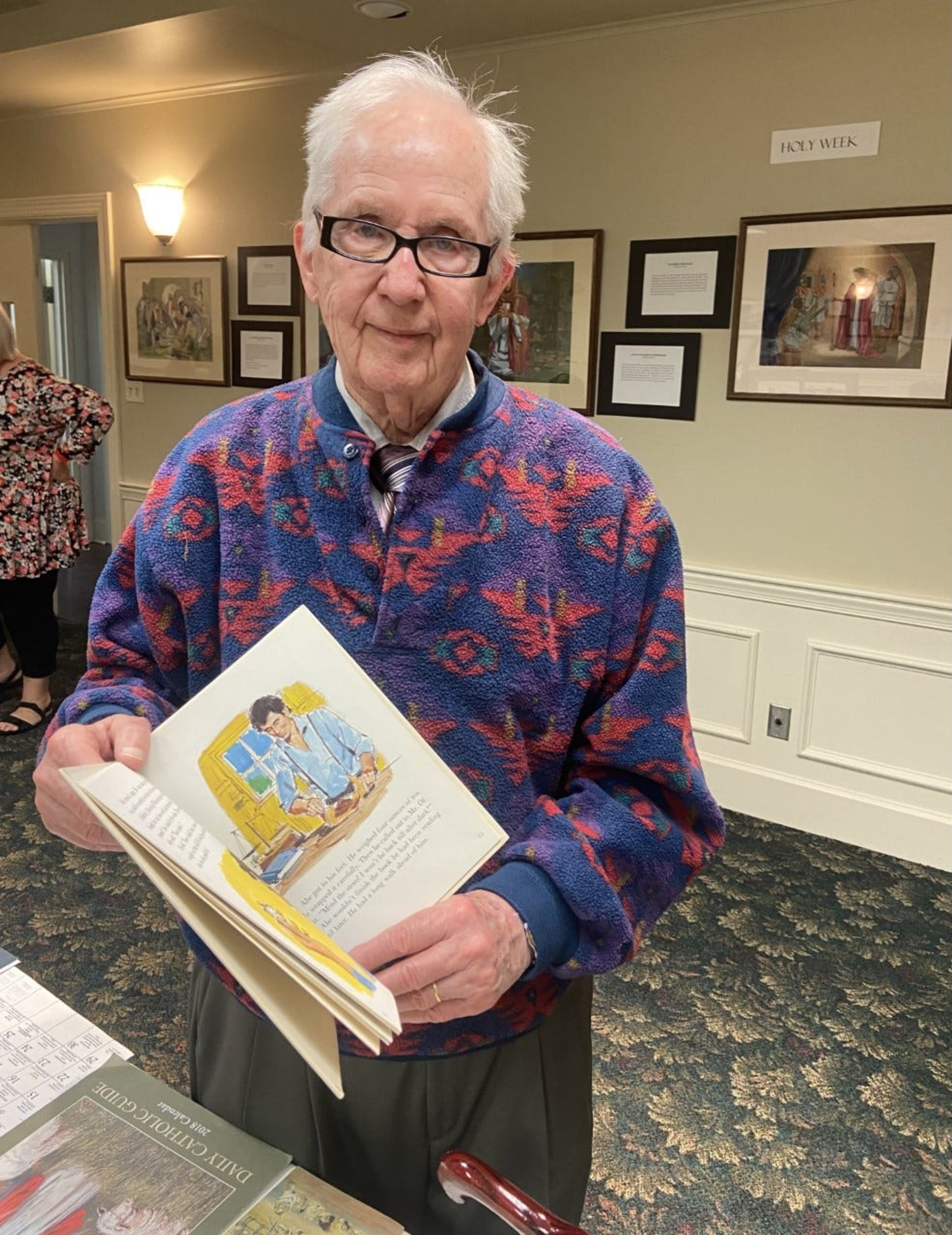 John Nelson shows off his drawing of Abraham Lincoln from a book he illustrated about the 16th U.S. President.