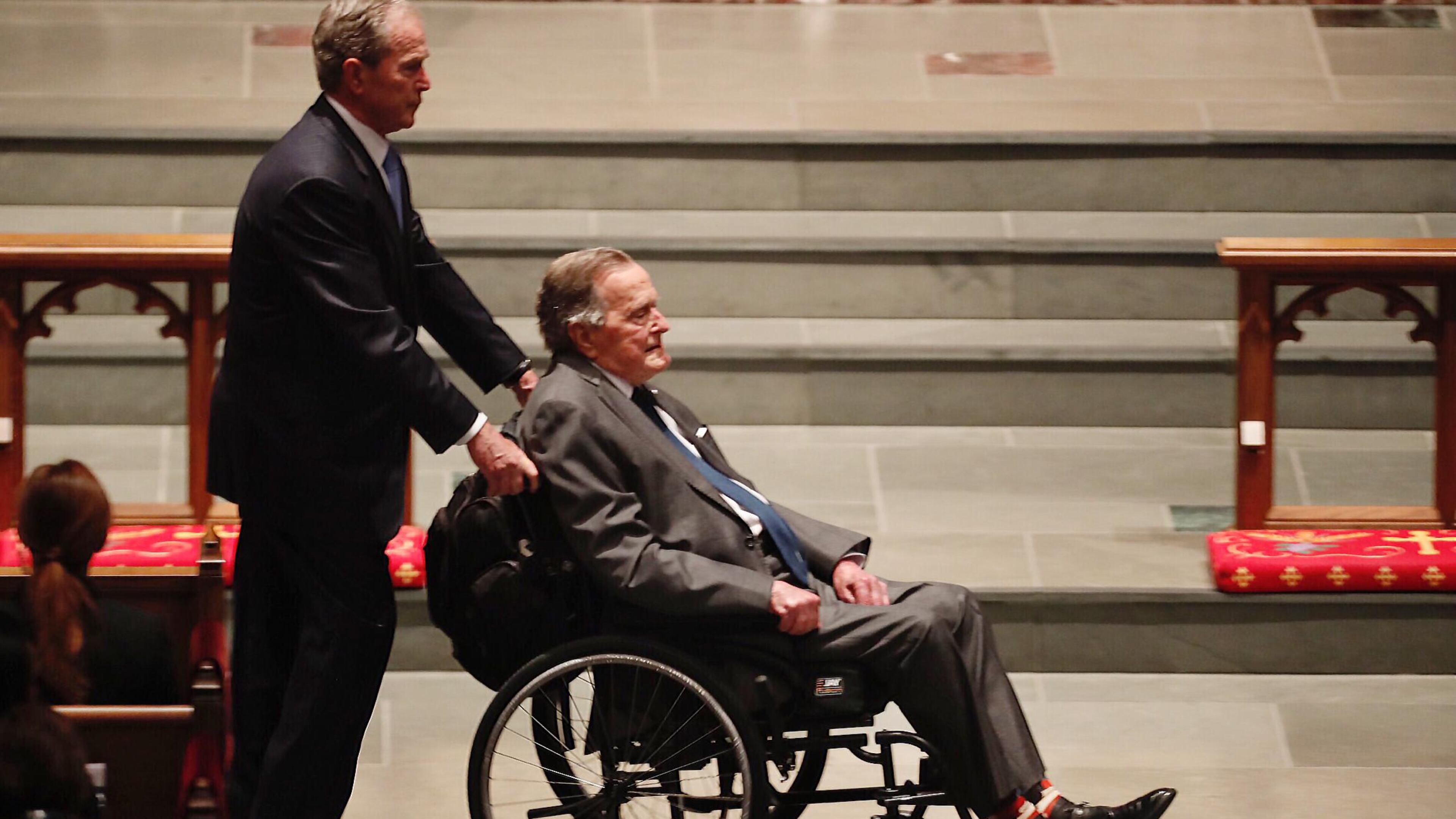 HOUSTON, TX - APRIL 21: Former President George H.W. Bush, assisted by his son, former President George W. Bush, enter the church during the funeral for former First Lady Barbara Bush on April 21, 2018 in Houston, Texas. (Photo by Brett Coomer - Pool/Getty Images)