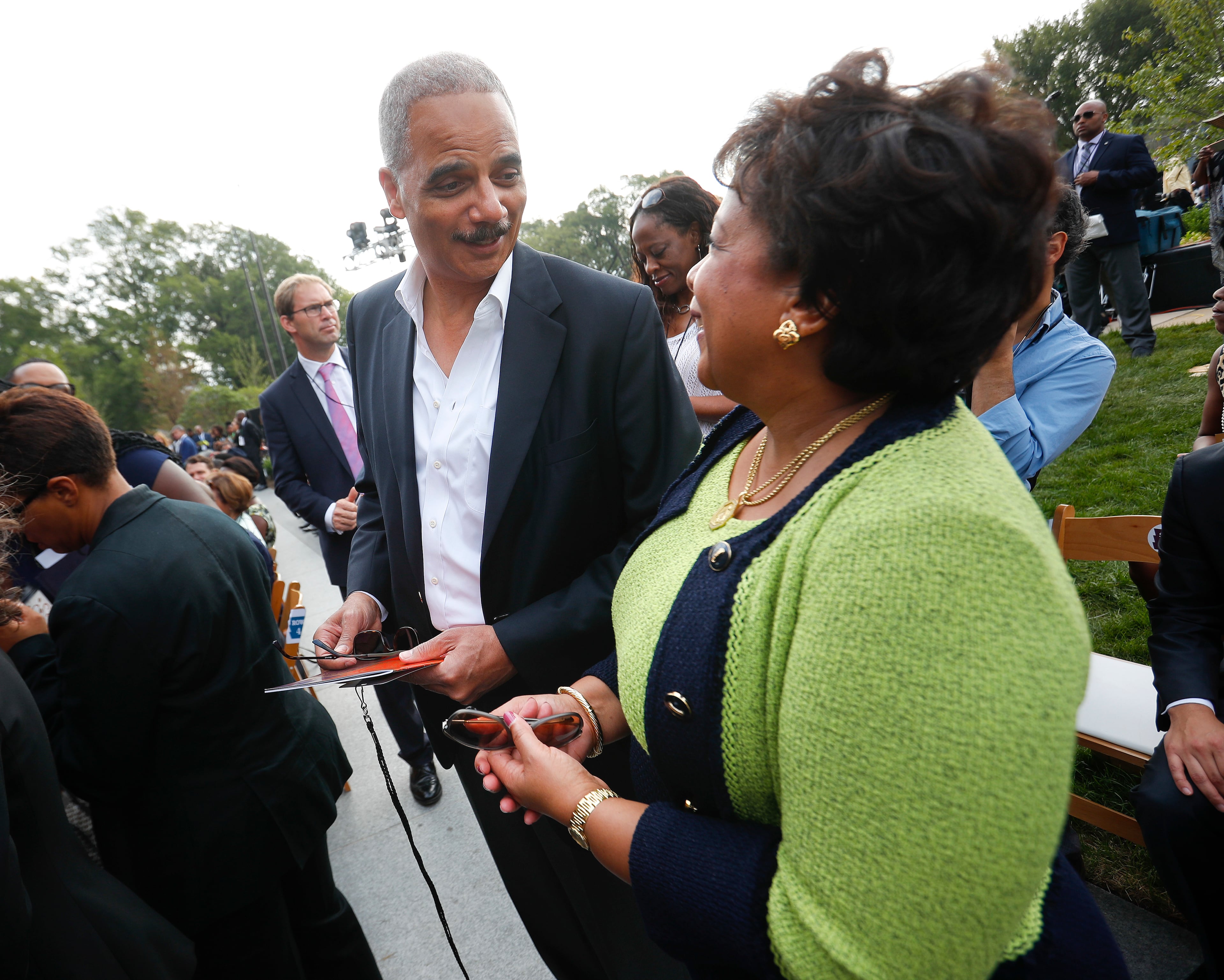 Former Attorney General Eric Holder, left, talks with current Attorney General Loretta Lynch as they arrive for the dedication ceremony of the Smithsonian Museum of African American History and Culture on the National Mall in Washington, Saturday, Sept. 24, 2016. (AP Photo/Pablo Martinez Monsivais)