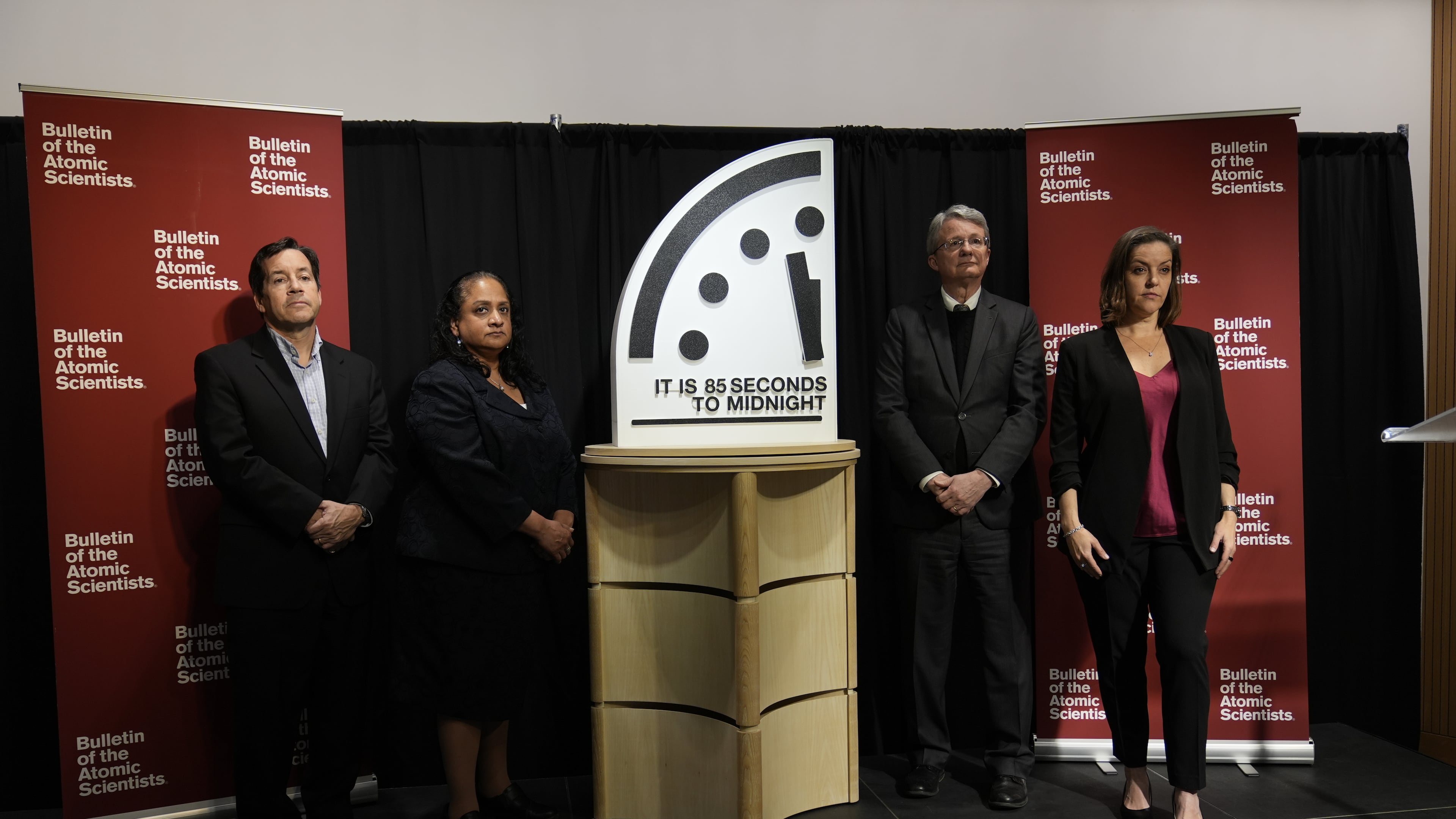 The Bulletin of the Atomic Scientist members, from left, Jon B. Wolfsthal, Asha M. George, Steve Fetter and Alexandra Bell, reveal the Doomsday Clock, set to 85 seconds to midnight, during a news conference at the Carnegie Endowment for International Peace, Friday, Jan. 23, 2026, in Washington. (AP Photo/Pablo Martinez Monsivais)
