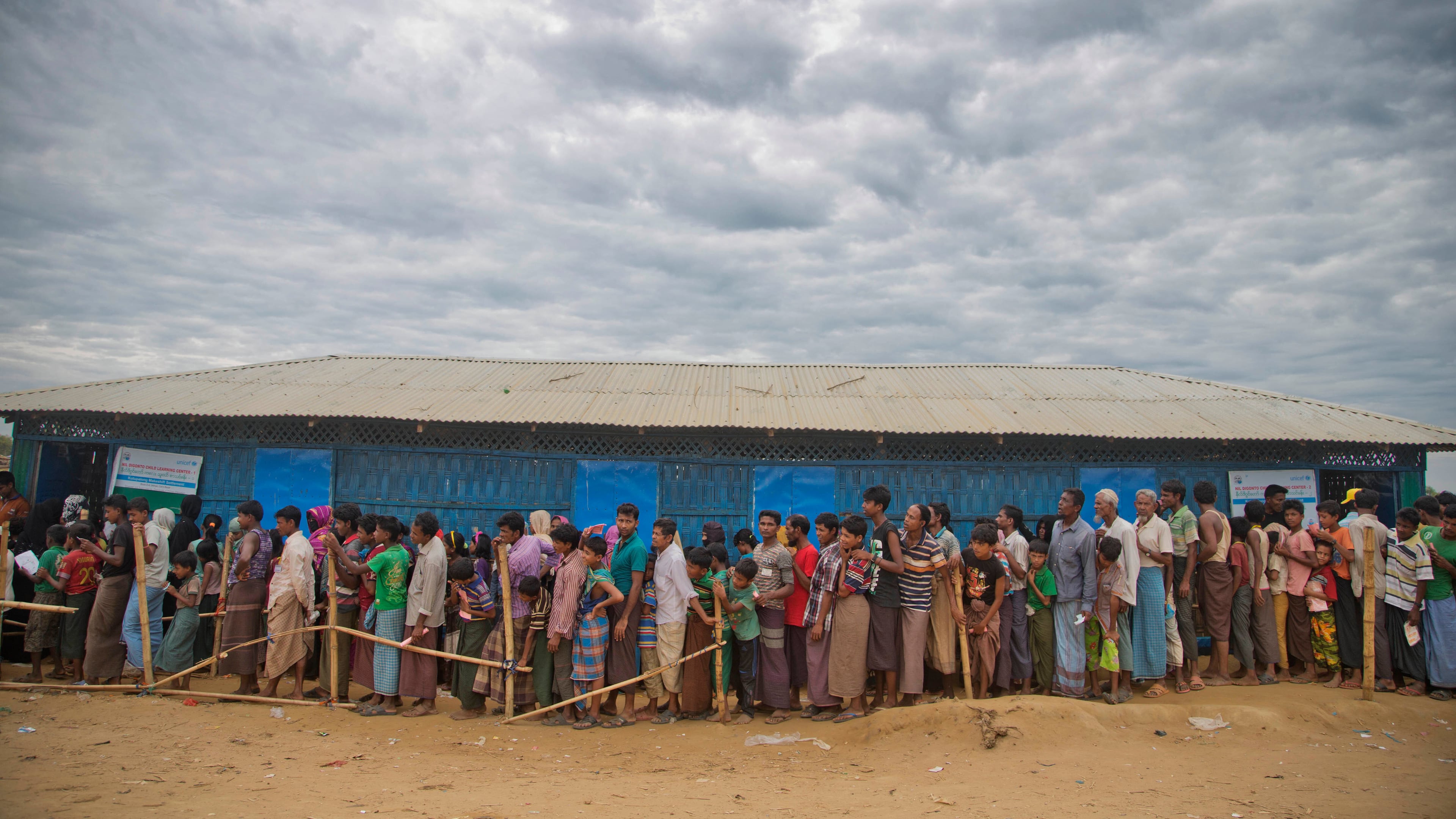 FILE -Rohingya Muslims, who crossed over from Myanmar into Bangladesh, wait in queues to receive aid at Kutupalong refugee camp in Ukhiya, Bangladesh, Nov. 15, 2017. (AP Photo/A.M. Ahad, File)