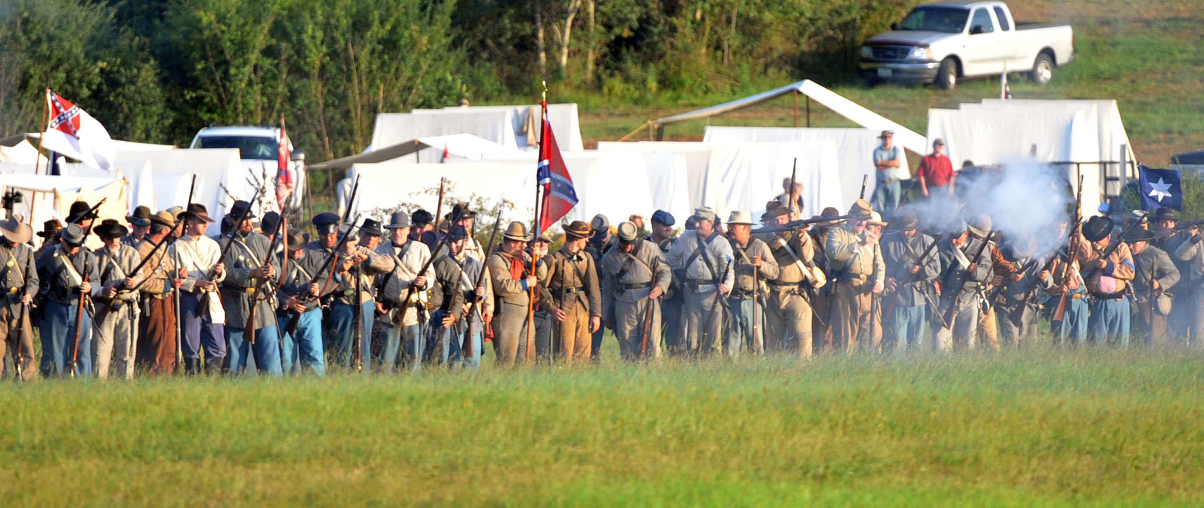Confederate troops fire on the Federal lines. Confederate and Union reenactors recreate the Battle of Utoy Creek during the Atlanta Campaign's Battle of Atlanta re-enactment at the Nash Farm Battlefield Friday, September 19, 2014. Thousands of re-enactors and spectators are expected to descend on Nash Farm Battlefield for this weekend's Battle of Atlanta events starting Friday and ending Sunday afternoon. Kilpatrick's Raid, the Battle of Cheatham's Hill, and Battle of Atlanta will be reenacted Saturday and Sunday. Confederate and Federal troops are in separate encampments about a 1/2 mile apart at the site. KENT D. JOHNSON / KDJOHNSON@AJC.COM