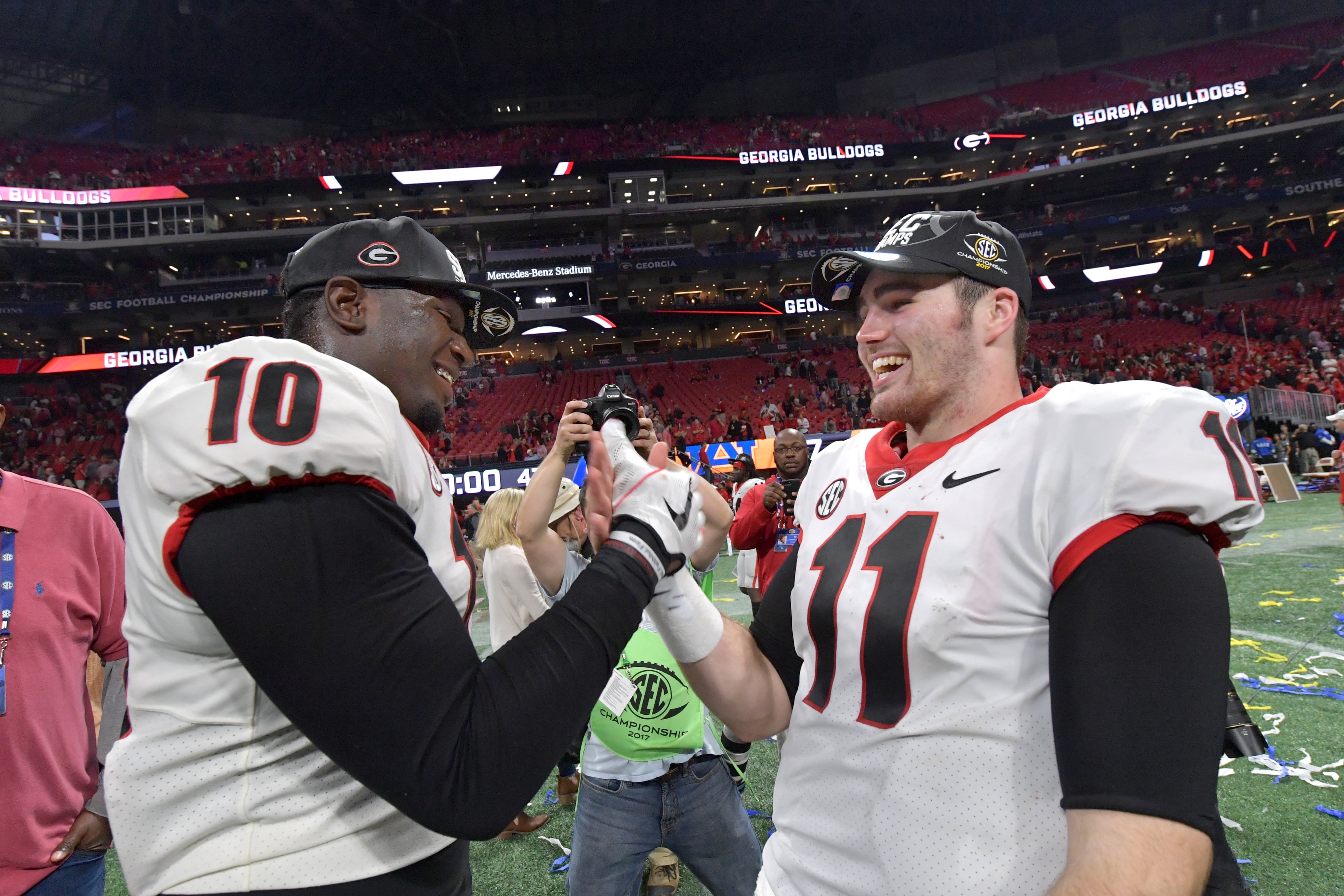 December 2, 2017 Atlanta: Georgia defensive lineman Malik Herring (10) and Georgia quarterback Jake Fromm (11) celebrate after their victory over the Auburn during the Southeastern Conference championship NCAA college football game at Mercedes-Benz Stadium, December 2, 2017, in Atlanta. Hyosub Shin / hshin@ajc.com